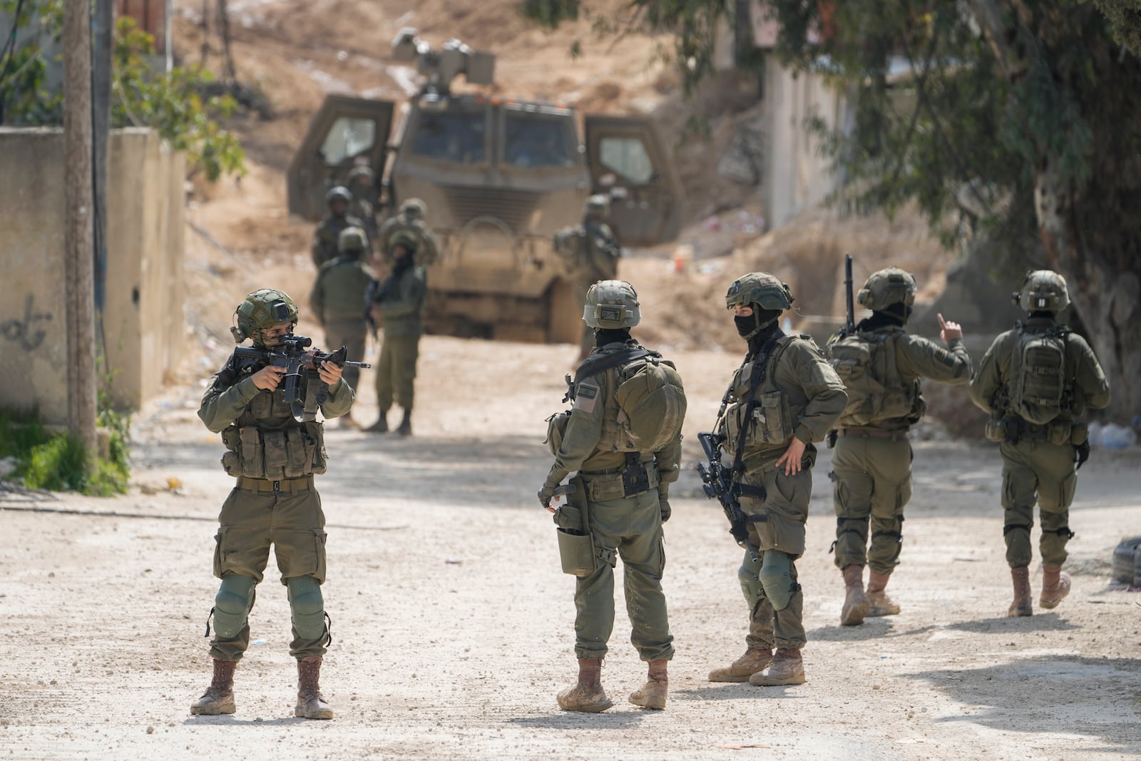 Israeli soldiers take position during an ongoing army operation in the West Bank urban refugee camp of Nur Shams on Wednesday, March 5, 2025. (AP Photo/Majdi Mohammed)