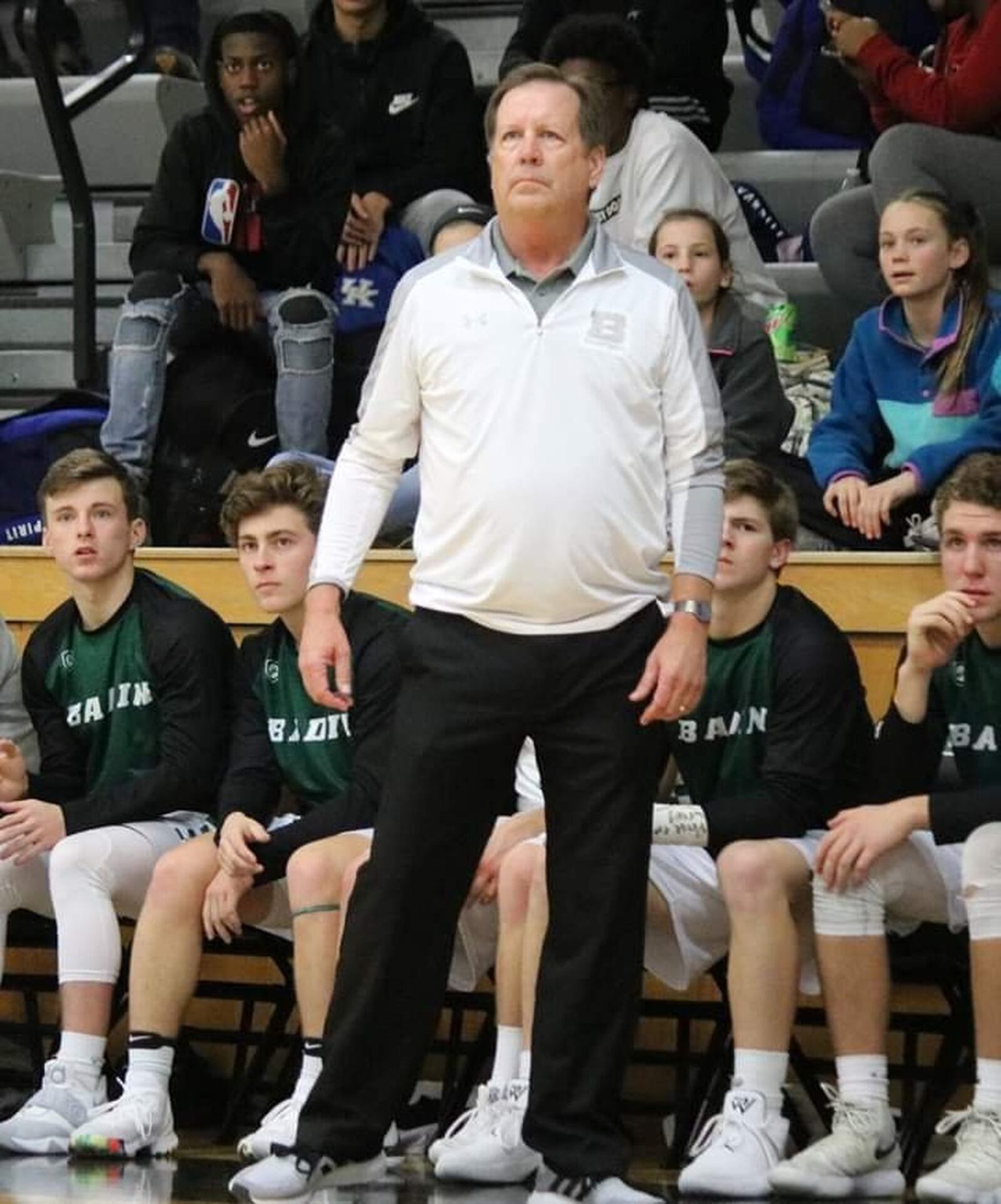 Badin coach Gerry Weisgerber glances up at the scoreboard Tuesday night during the Rams’ 70-52 win over visiting Northwest at Mulcahey Gym in Hamilton. CONTRIBUTED PHOTO BY TERRI ADAMS