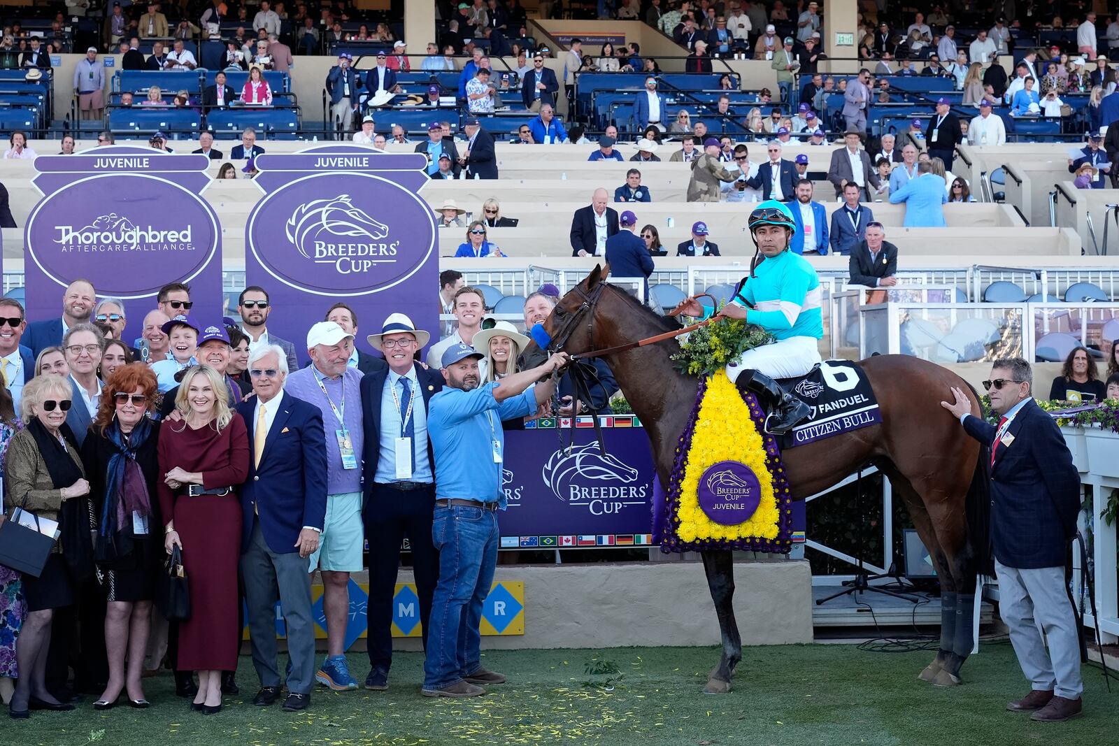 Martin Garcia, middle right, celebrates after riding Citizen Bull to victory in the Breeders' Cup Juvenile horse race at Santa Anita Park in Del Mar, Calif., Friday, Nov. 1, 2024. (AP Photo/Gregory Bull)