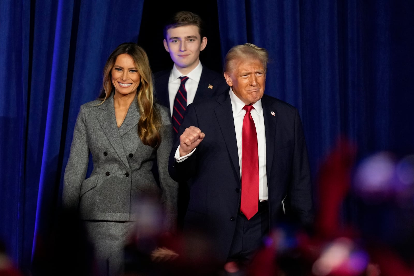 Republican presidential nominee former President Donald Trump, joined by, from right, Melania Trump and Barron Trump, arrives to speaks at an election night watch party, Wednesday, Nov. 6, 2024, in West Palm Beach, Fla. (AP Photo/Alex Brandon)