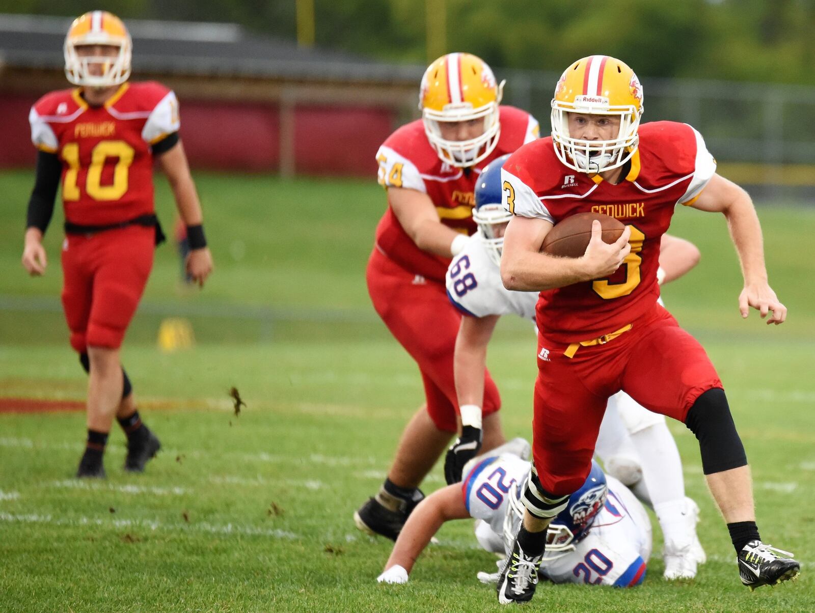 Fenwick’s Jack Fessler (3) gets past Clinton-Massie’s Tyler Beam (20) and Braxton Green (68) during Friday night’s game at Krusling Field in Middletown. Massie picked up a 21-18 win. CONTRIBUTED PHOTO BY ANGIE MOHRHAUS