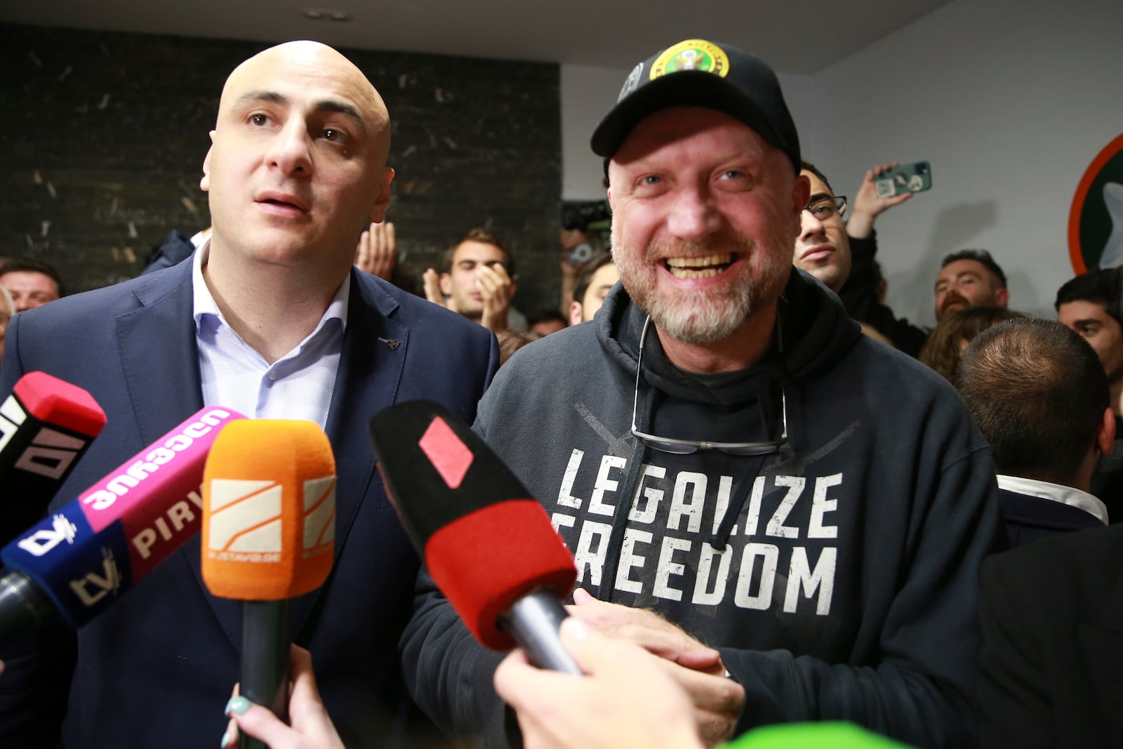 From left, Nika Melia, leader of Coalition for Changes, and Zurab Japaridze, chairman of the Girchi More Freedom party, talk to journalists at coalition's headquarters after polls closing at the parliamentary election in Tbilisi, Georgia, Saturday, Oct. 26, 2024. (AP Photo/Zurab Tsertsvadze)