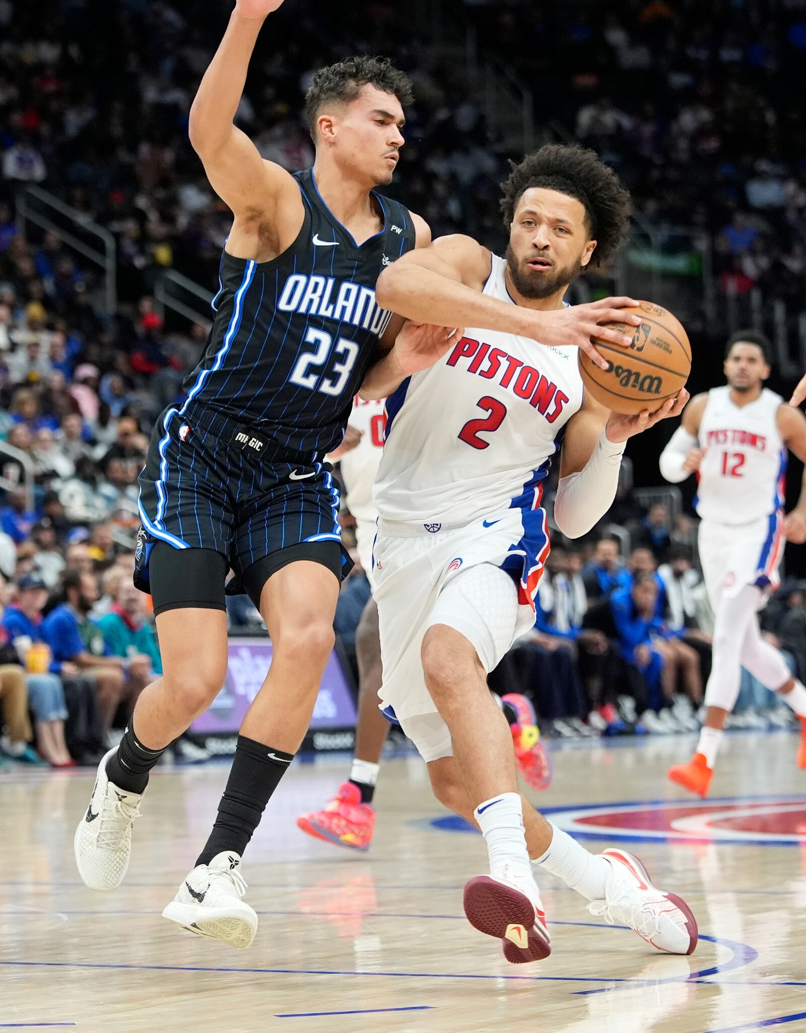 Detroit Pistons guard Cade Cunningham (2) drives as Orlando Magic forward Tristan da Silva (23) defends during the first half of an NBA basketball game, Wednesday, Jan. 1, 2025, in Detroit. (AP Photo/Carlos Osorio)