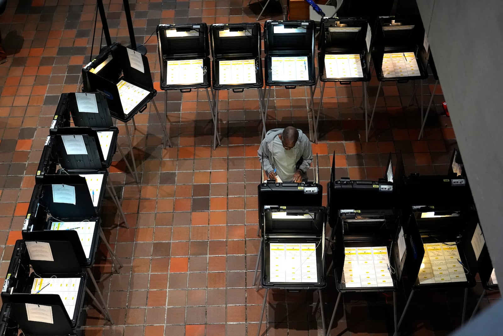 FILE - A person votes on the first day of early voting in the general election, Oct. 21, 2024, in Miami. (AP Photo/Lynne Sladky, File)