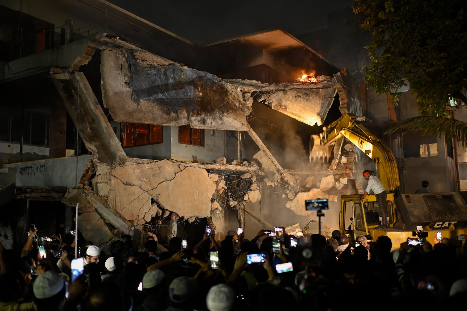 Protesters use heavy machinery to demolish the residence of Sheikh Mujibur Rahman, Bangladesh's former leader and the father of the country's ousted Prime Minister Sheikh Hasina, at Dhanmondi in Dhaka, Bangladesh, Thursday, Feb. 6, 2025. (AP Photo/Mahmud Hossain Opu)