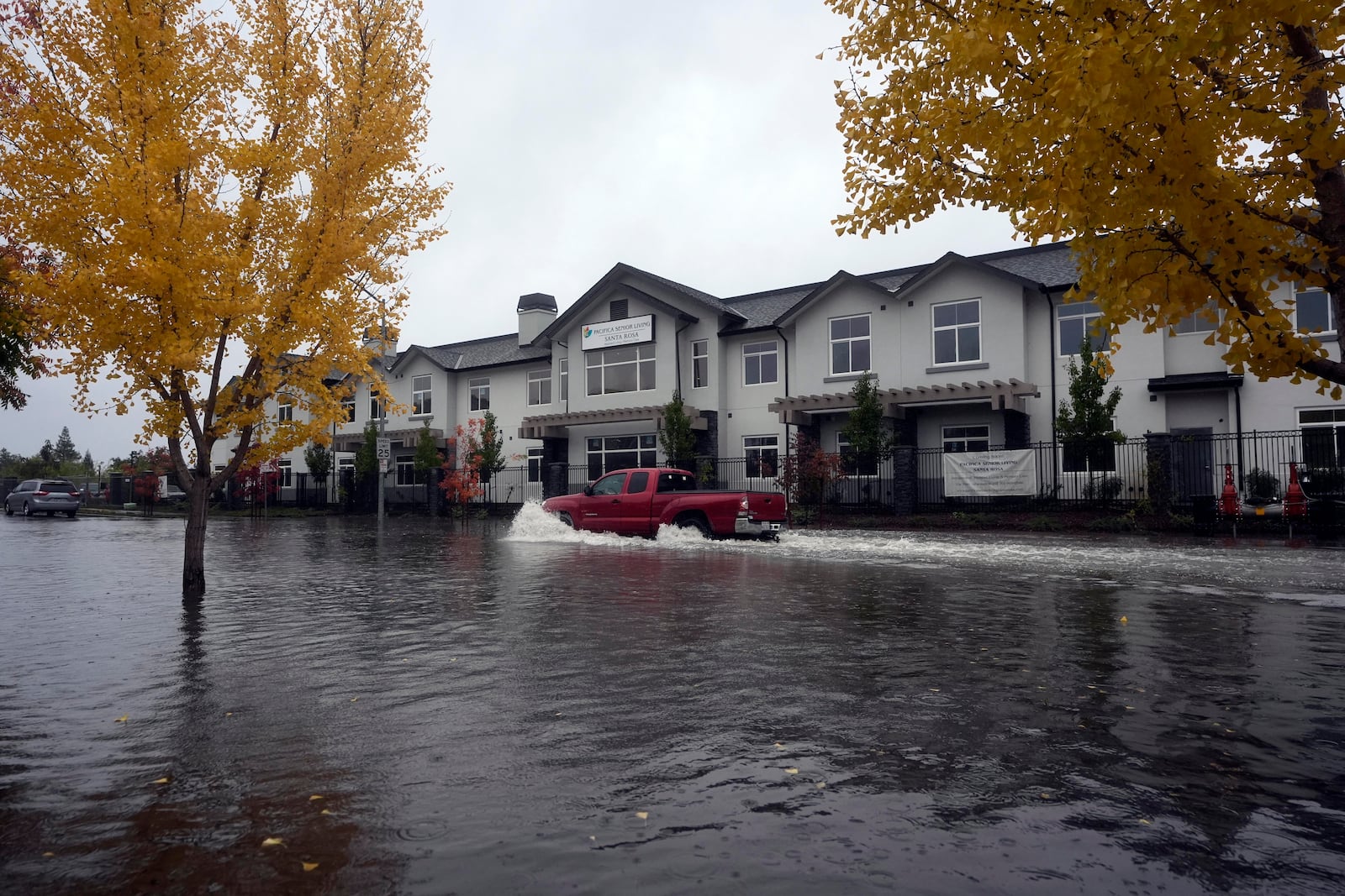 A pickup truck makes its way through a flooded street in Santa Rosa, Calif. Thursday, Nov. 21, 2024. (AP Photo/Jeff Chiu)