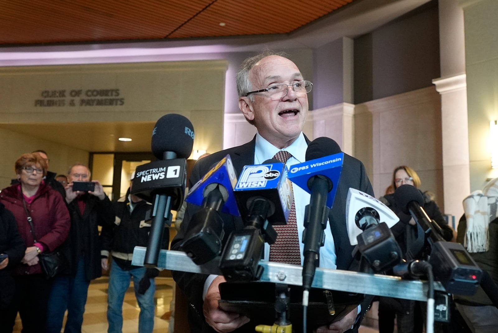 Jim Troupis reads a statement after his court appearance outside a Dane County courtroom Wednesday, Dec. 12, 2024, in Madison, Wis. (AP Photo/Morry Gash)