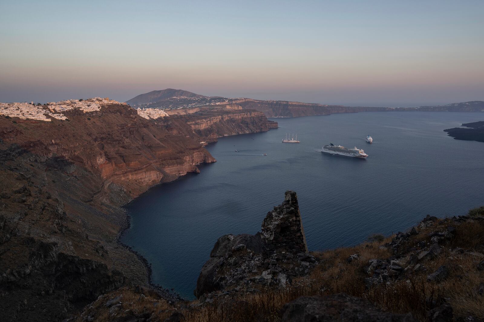 FILE - Ruins of a settlement, including a former Catholic monastery, lie on the rocky promontory of Skaros on the Greek island of Santorini, on June 15, 2022. (AP Photo/Petros Giannakouris, File)