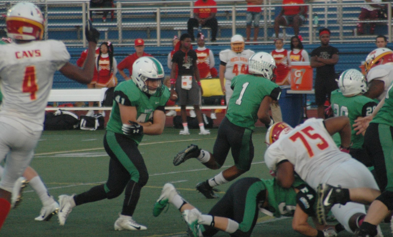 Badin’s Ethan Wishart (41) carries out a fake as teammate Davon Starks (1) heads around the left side during Saturday night’s game against Purcell Marian at Monroe. Badin won 24-7. RICK CASSANO/STAFF