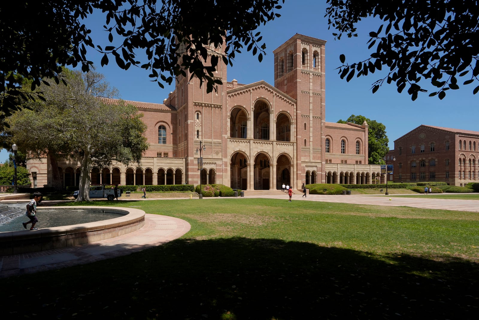 FILE - Children play outside Royce Hall at the University of California, Los Angeles, campus in Los Angeles, Aug. 15, 2024. (AP Photo/Damian Dovarganes, File)