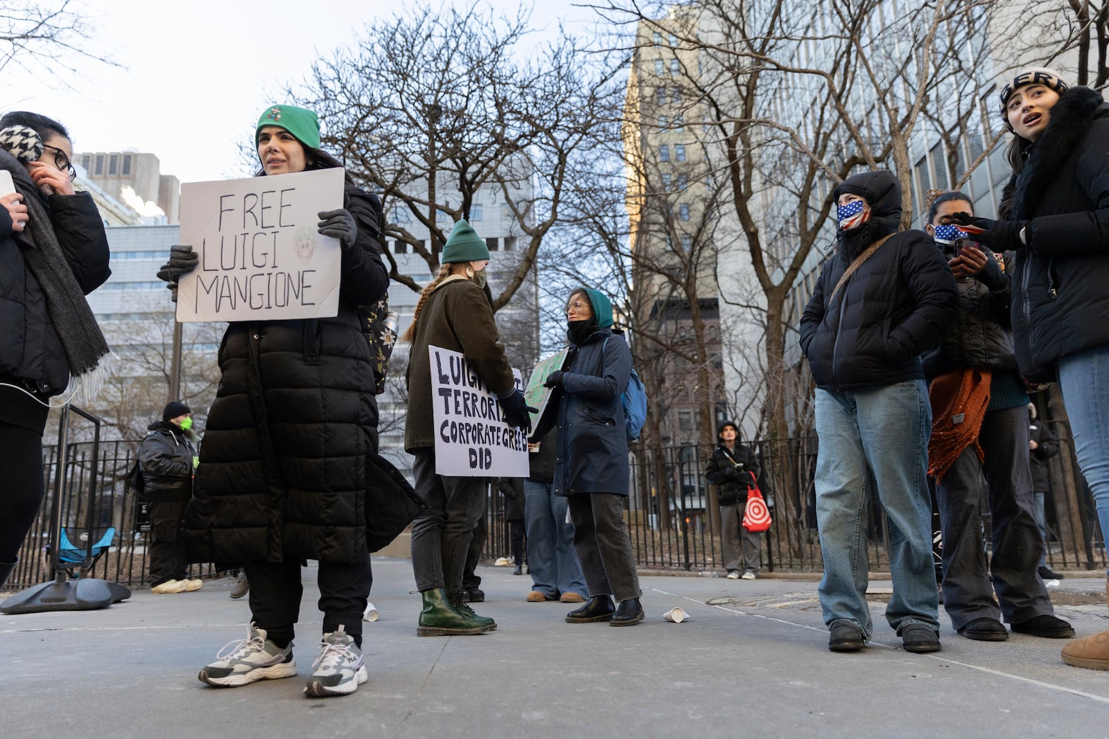 Luigi Mangione supporters hold signs outside the Supreme Court on Friday, Feb. 21, 2025 in New York. (AP Photo/Stefan Jeremiah)