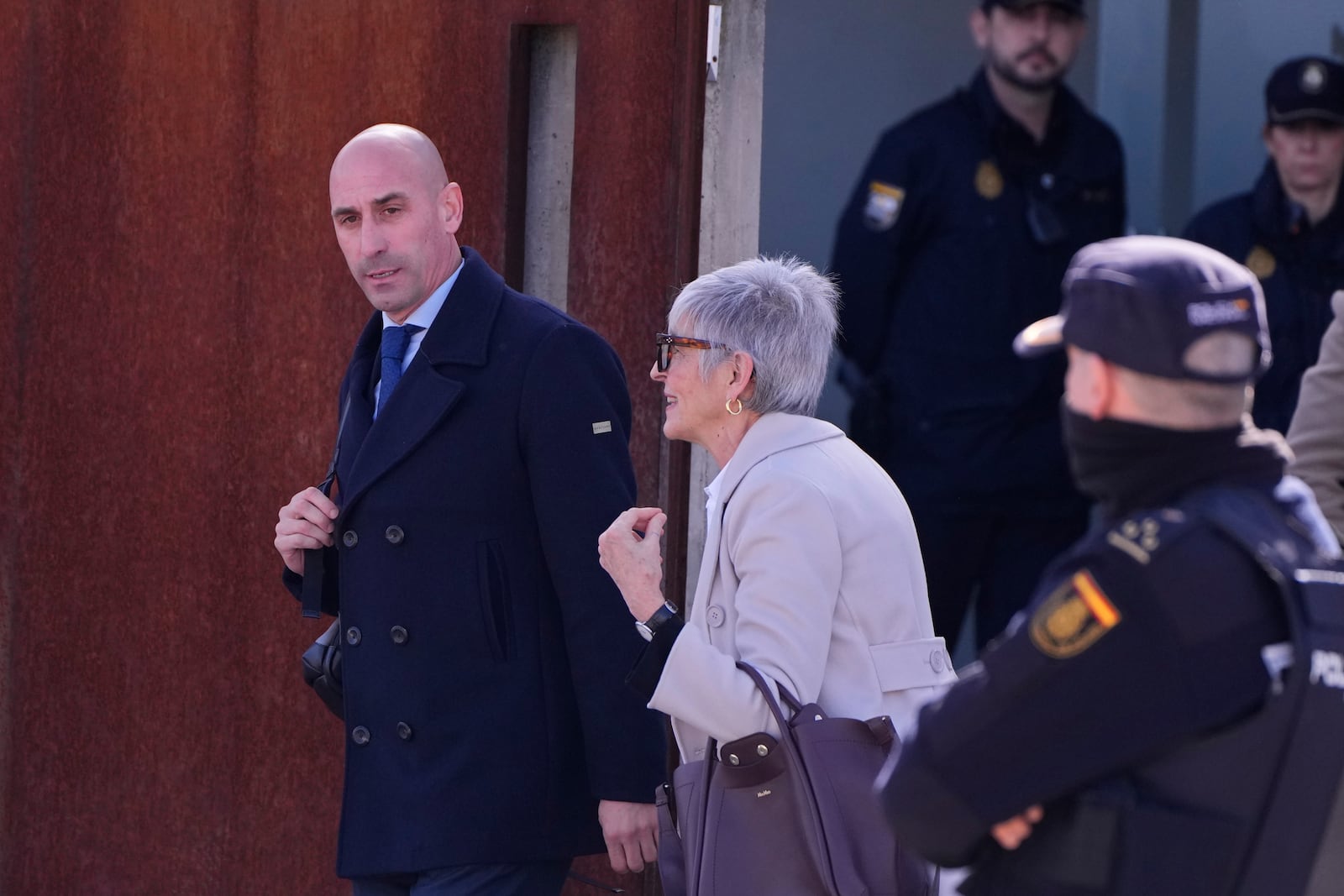 The former president of Spain's soccer federation Luis Rubiales, left, leaves a court with his lawyer Olga Tubau on the outskirts of Madrid, Spain, Monday Feb. 3, 2025 where he is on trial for his unsolicited kiss on forward Jenni Hermoso. (AP Photo/Manu Fernandez)