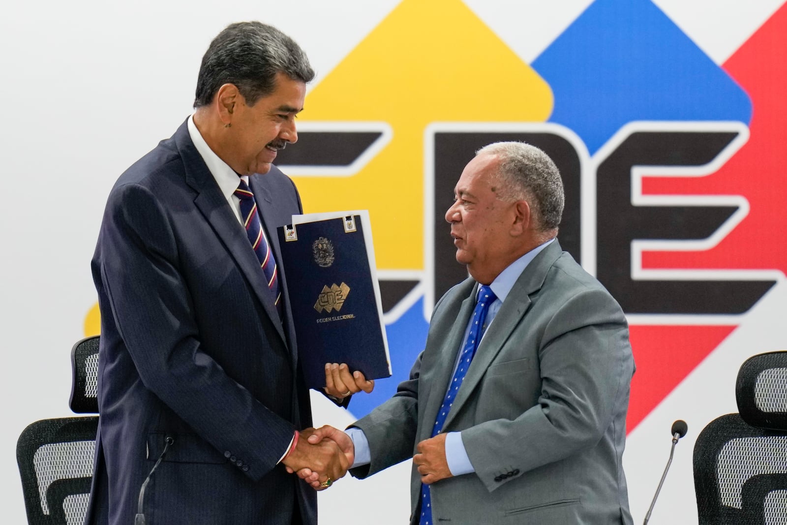 FILE - Venezuelan President Nicolas Maduro, left, shakes hands with National Electoral Council President Elvis Amoroso after declaring Maduro the winner of the presidential election, in Caracas, Venezuela, July 29, 2024. (AP Photo/Matias Delacroix, File)