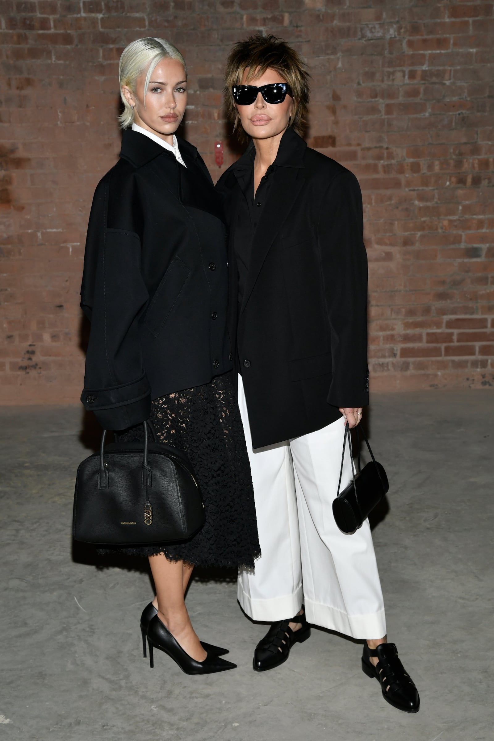 Delilah Hamlin, left, and Lisa Rinna arrive at the Michael Kors Fall/Winter 2025 fashion show as part of New York Fashion Week on Tuesday, Feb. 11, 2025, at Terminal Warehouse in New York. (Photo by Evan Agostini/Invision/AP)