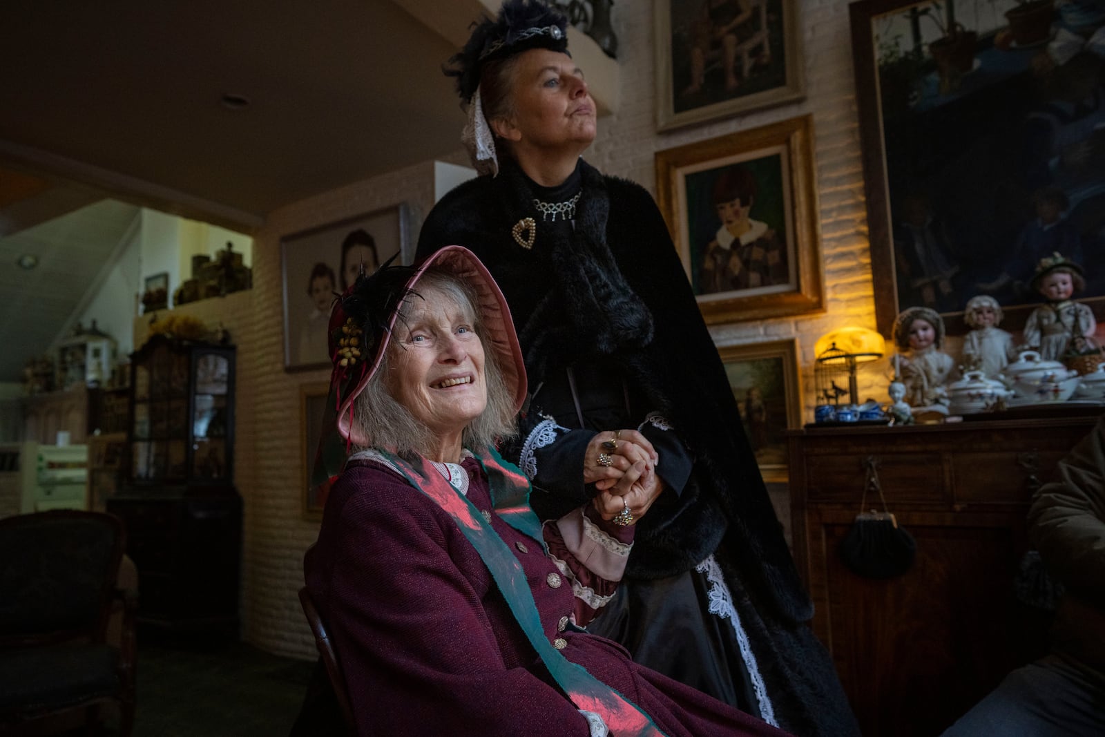 Emmy Strik, left, who started the Deventer Dickens Day, and Sandra Nieland who plays Queen Victoria, are interviewed as people in costumes from Charles Dickens' 19th-century English era take part in a Dickens Festival, in Deventer, Netherlands, Saturday, Dec. 14, 2024. (AP Photo/Peter Dejong)