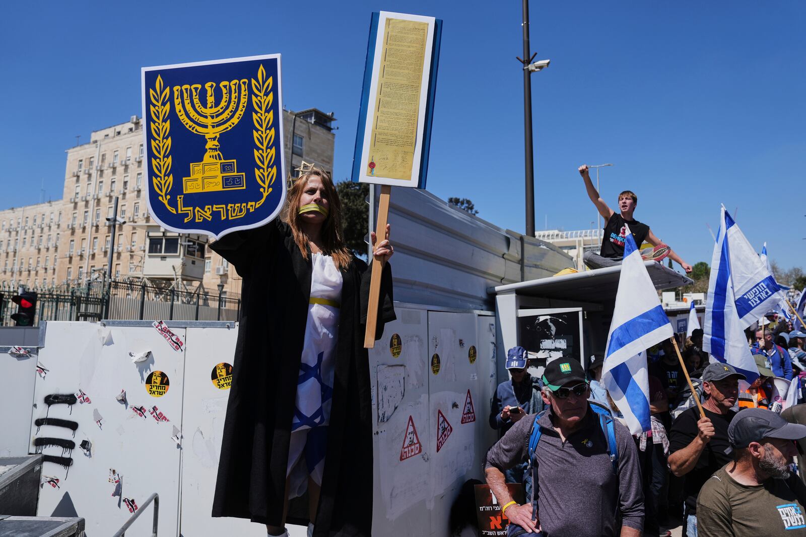 People protest a outside the Knesset, Israel's parliament, in Jerusalem on Sunday, March 23, 2025, as the Israeli cabinet is set to hold a no-confidence vote against Attorney General Gali Baharav-Miara. (AP Photo/Ohad Zwigenberg)