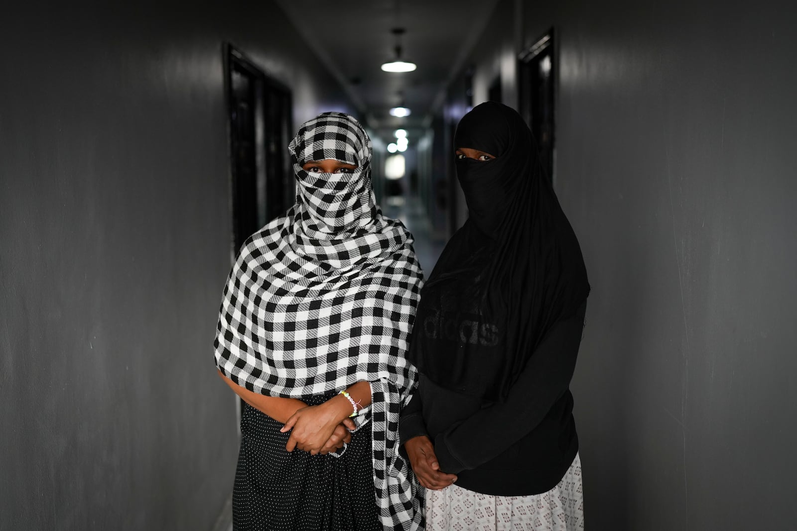 Qamar Abdi and Filsan Aliin, migrants from Somalia, pose for a portrait at the hotel where they are staying in Panama City, Monday, March 10, 2025, after being deported from the United States, detained for weeks in a Panamanian immigration camp, and released on a temporary humanitarian visa allowing a 30‑day stay. (AP Photo/Matias Delacroix)