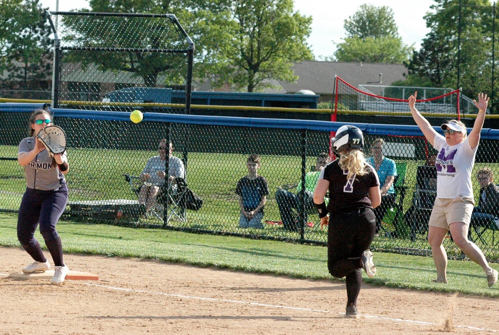 Middletown’s Katie Pearson (7) is about to be out on the throw to Fairmont first baseman Hannah Gagel on Tuesday during a Division I district softball semifinal at Miamisburg. Fairmont won 7-2. RICK CASSANO/STAFF