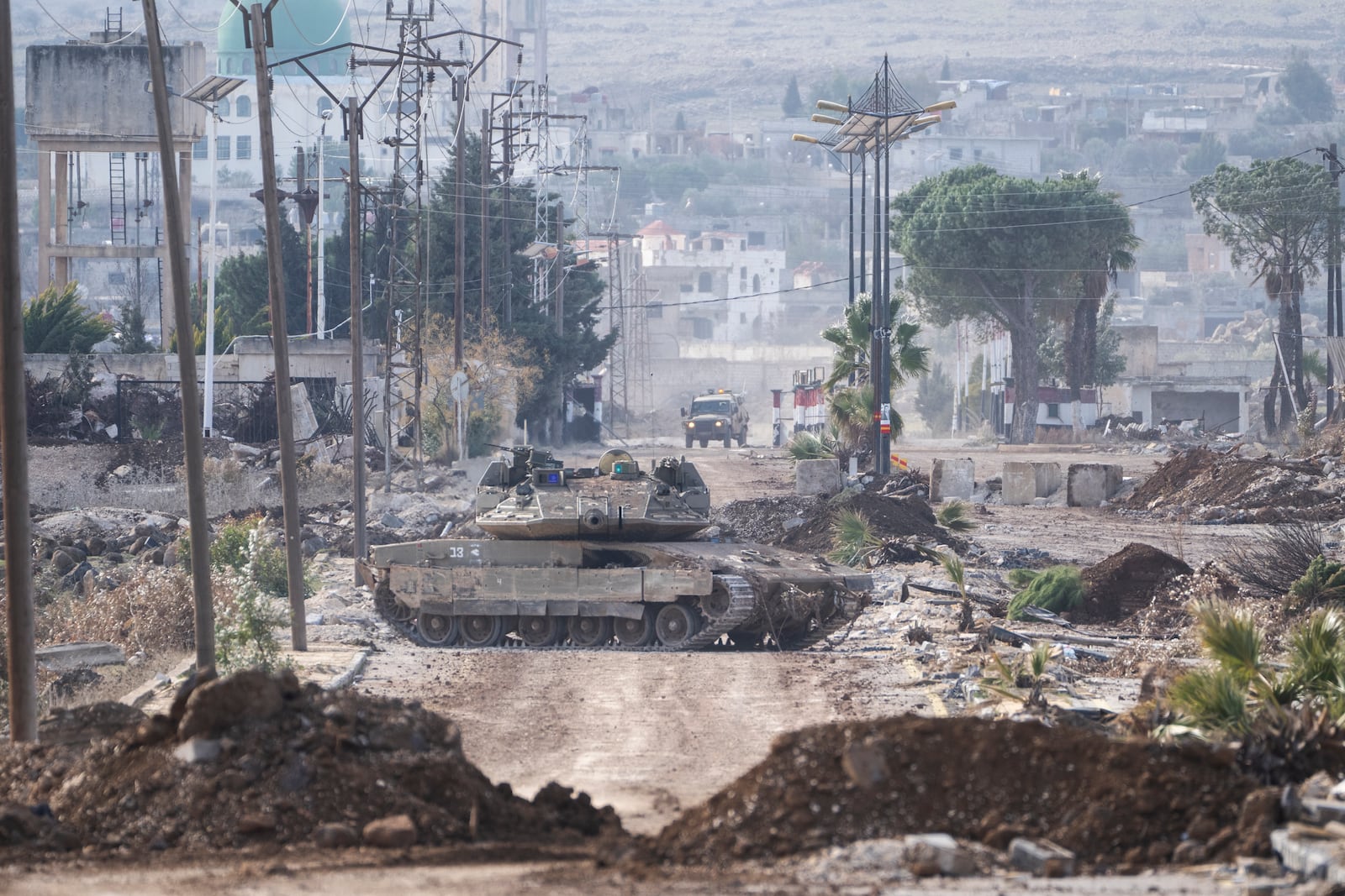 Israeli military armored vehicles block a road leading to the town of Quneitra, Syria, Sunday, Jan. 5, 2025. (AP Photo/Mosa'ab Elshamy)