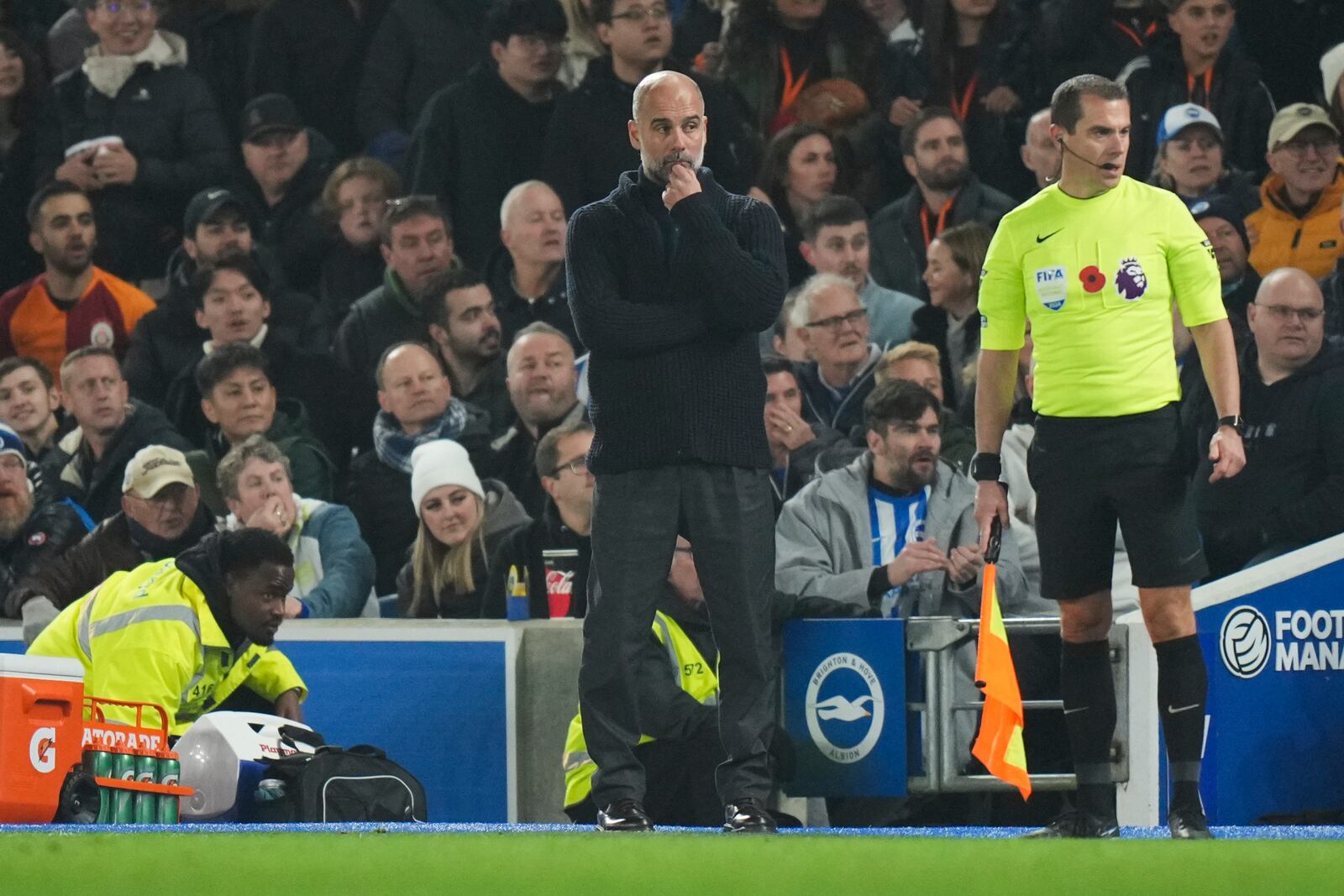 Manchester City's head coach Pep Guardiola watches the end of the English Premier League soccer match between Brighton and Manchester City at Falmer Stadium in Brighton, England, Saturday, Nov. 9, 2024. (AP Photo/Alastair Grant)