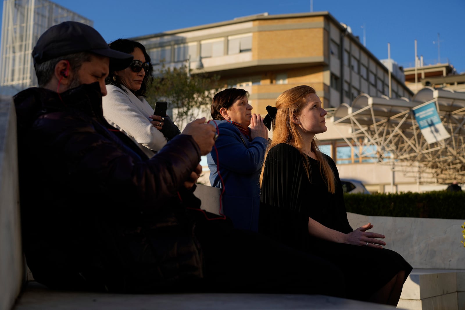 Michelle Van Asperen, of the Netherlands, prays for Pope Francis outside the Agostino Gemelli Polyclinic in Rome, Tuesday, March 4, 2025. (AP Photo/Gregorio Borgia)