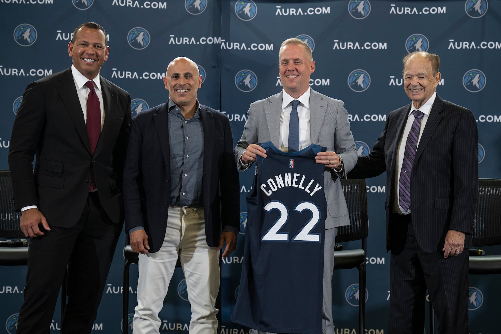 FILE - Minnesota Timberwolves Ownership Group Alex Rodriguez, left, Marc Lore,, second from left, and Glen Taylor, right, pose with Timberwolves new President of Basketball Operations Tim Connelly (holding jersey) in Minneapolis, May 31, 2022. (Jerry Holt/Star Tribune via AP)