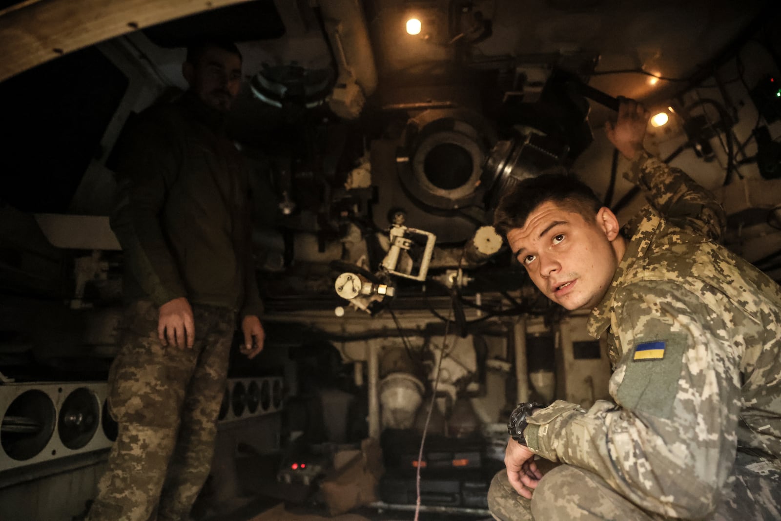 In this photo provided by Ukraine's 24th Mechanised Brigade press service, Ukrainian soldiers are seen inside a M109 self-propelled howitzer on the frontline on their position in Chasiv Yar, Donetsk region, Ukraine, Wednesday, Oct. 23, 2024. (Oleg Petrasiuk/Ukrainian 24th Mechanised Brigade via AP)