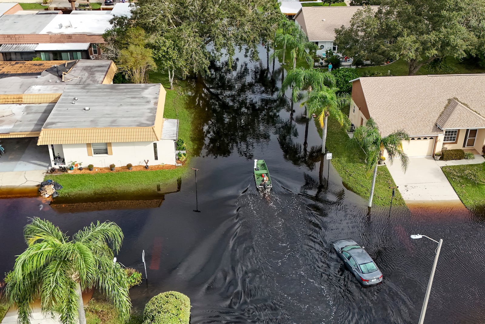 A member of the Pasco County Sheriff's Office goes out to help residents trapped in their homes as waters rise after Hurricane Milton caused the Anclote River to flood, Friday, Oct. 11, 2024, in New Port Richey, Fla. (AP Photo/Mike Carlson)