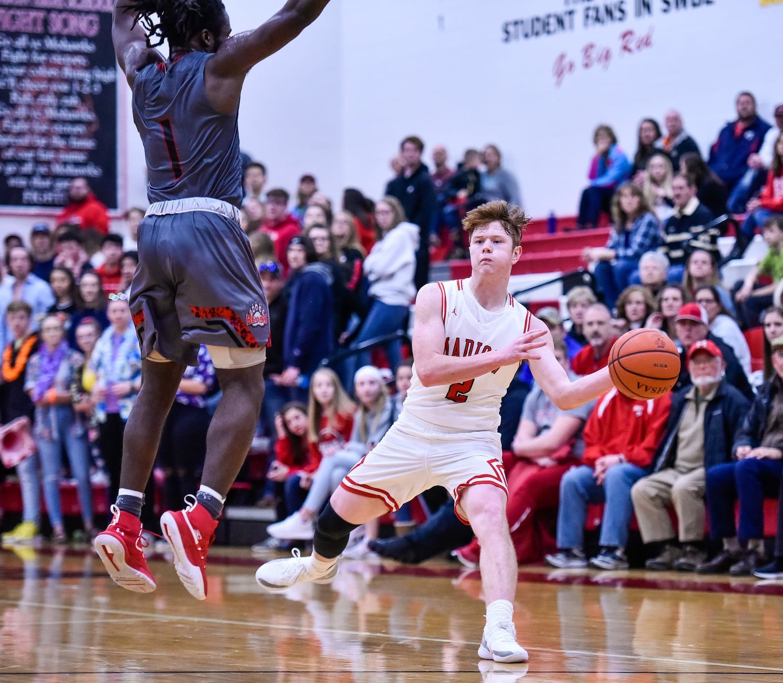 Madison’s Tristan Sipple passes the ball around Northridge’s Twon Hines during Friday night’s game in Madison Township. Northridge won 58-56. NICK GRAHAM/STAFF