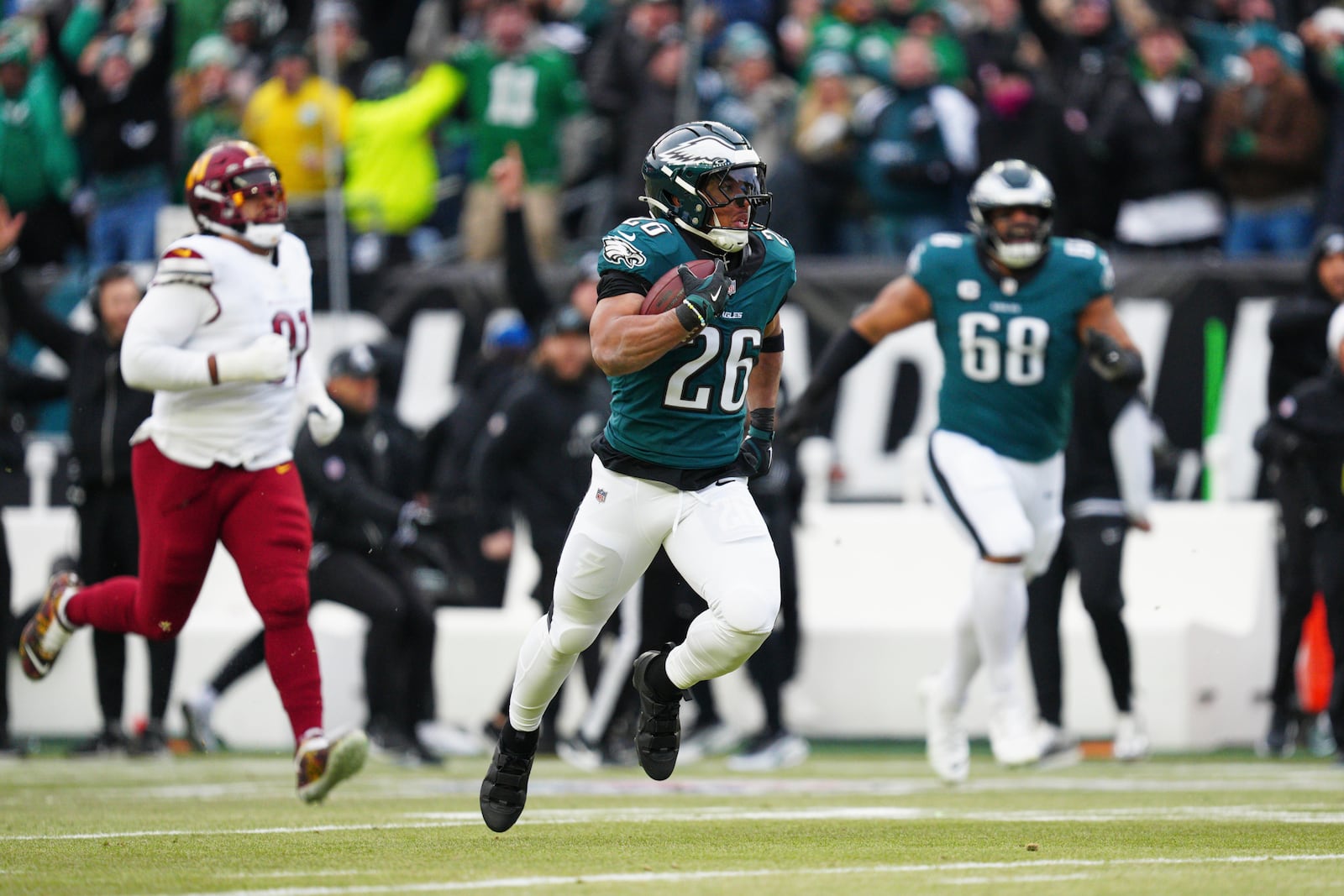 Philadelphia Eagles running back Saquon Barkley (26) runs for a touchdown against the Washington Commanders during the first half of the NFC Championship NFL football game, Sunday, Jan. 26, 2025, in Philadelphia. (AP Photo/Derik Hamilton)