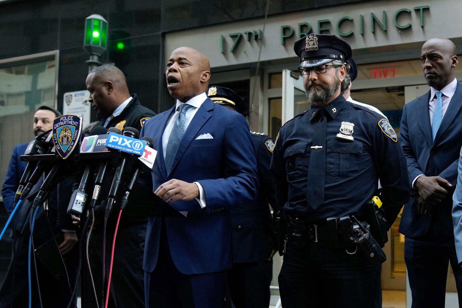 This image provided by Office of the New York Mayor shows New York Mayor Eric Adams, left center, as he briefs the media on a series of incidents that took place within the confines of the 10th and 17th Police Precincts, Monday, Nov. 18, 2024. (Mayoral Photography Office/Michael Appleton via AP)