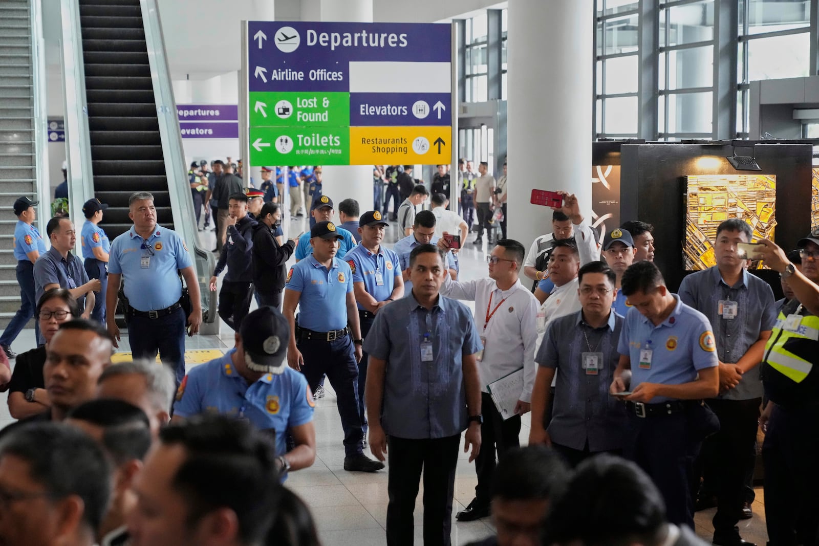 Security officers patrol the airport after former President Rodrigo Duterte was arrested, in Manila, Philippines, Tuesday, March 11, 2025. (AP Photo/Aaron Favila)