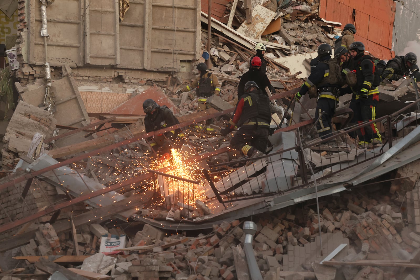 Rescue workers clear the rubble of a residential building destroyed by a Russian airstrike in Zaporizhzhia, Ukraine, November 7, 2024. (AP Photo/Kateryna Klochko)