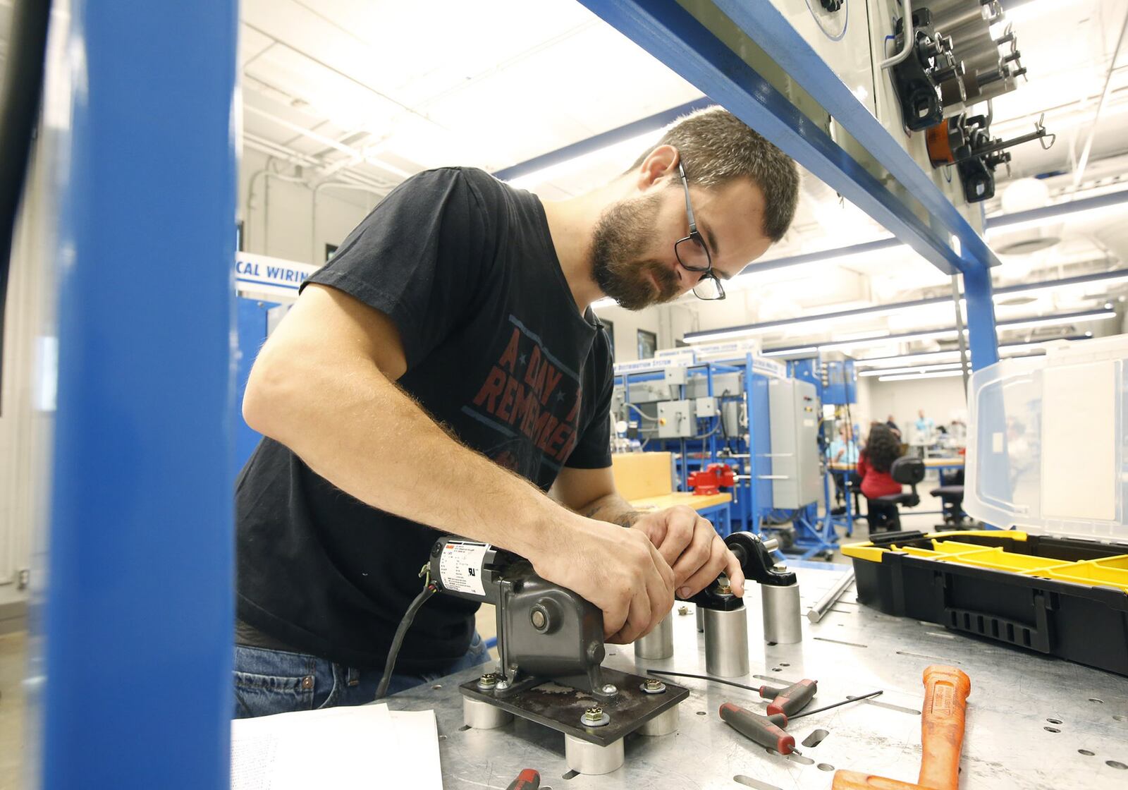 Zac Cox, 29, is completing course work in Sinclair’s Manufacturing Solutions program to improve his skills as a maintenance technician for his employer, F&P America Manufacturing in Troy. Workforce development is a key issue for candidates running for Ohio governor. TY GREENLEES / STAFF