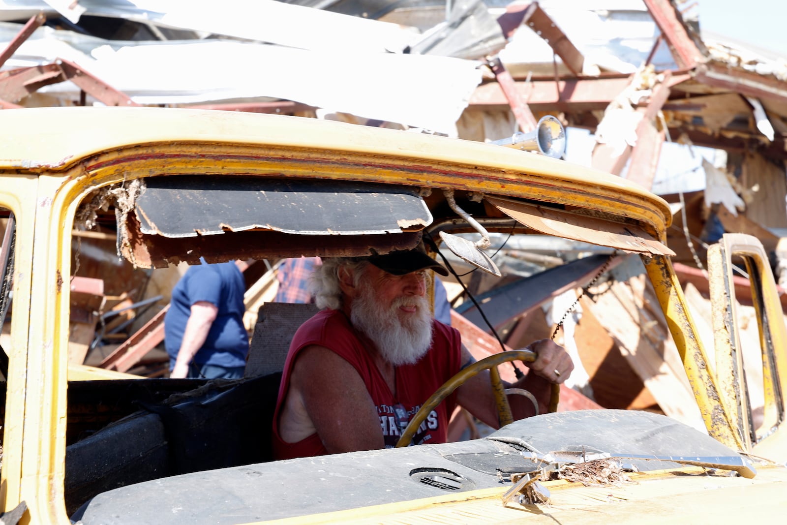 Tony Robertson drives a damaged pickup truck out of the way after a tornado passed through the area Sunday, March 16, 2025, in Plantersville, Ala. (AP Photo/Butch Dill)