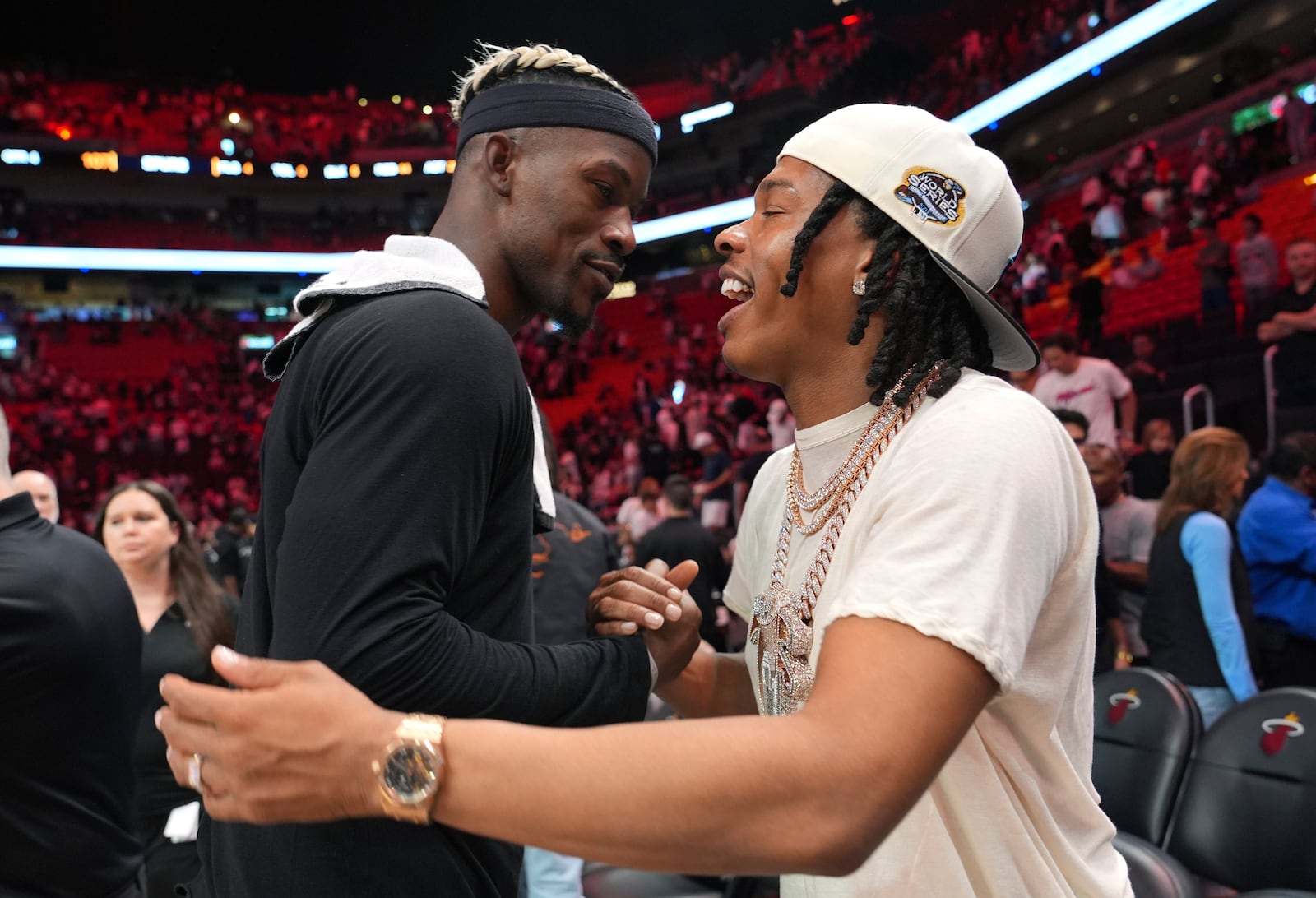 Miami Heat forward Jimmy Butler, left, greets rapper Lil Baby, right, after an NBA basketball game against the San Antonio Spurs, Sunday, Jan. 19, 2025, in Miami. (AP Photo/Lynne Sladky)