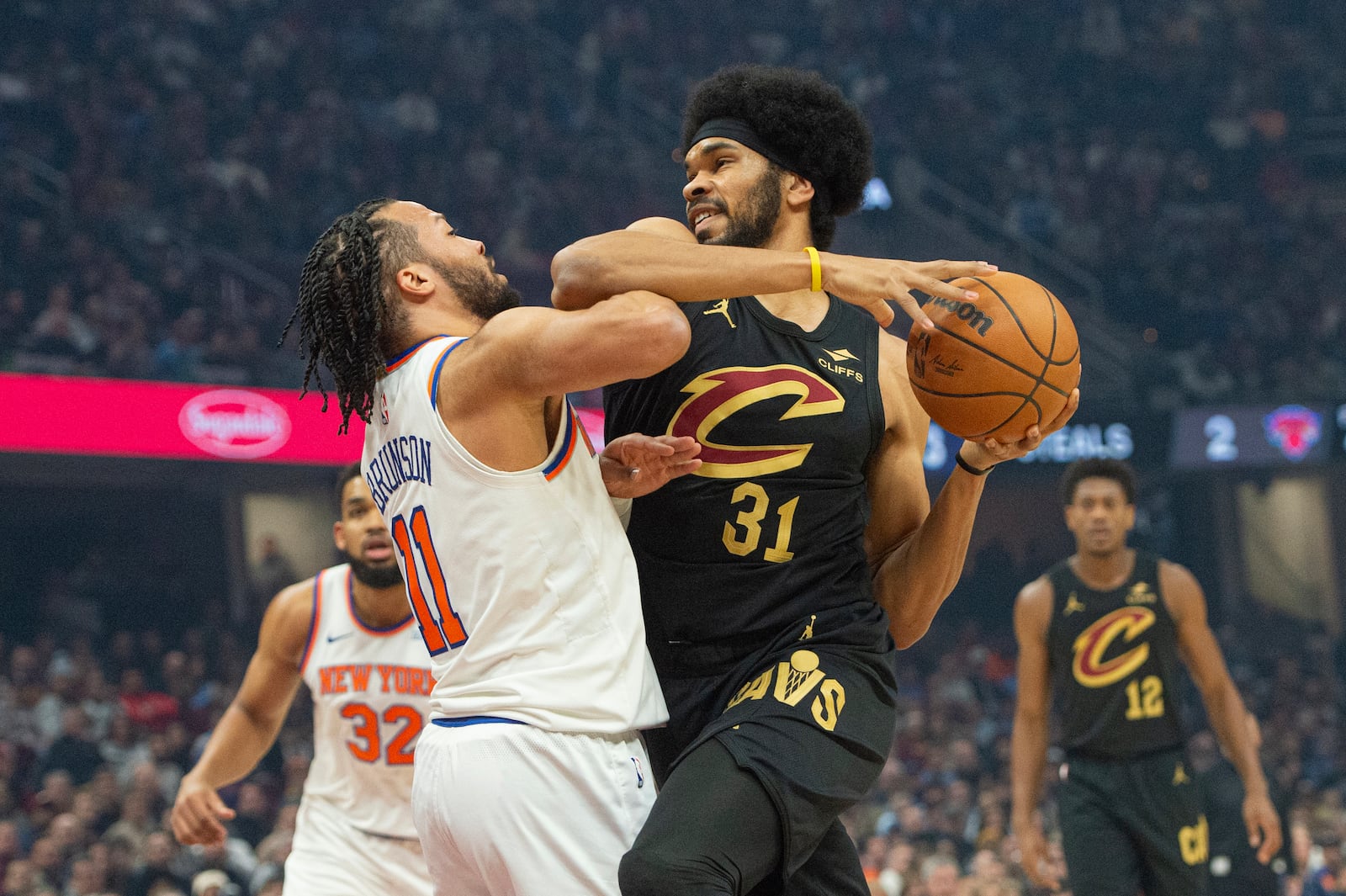 Cleveland Cavaliers' Jarrett Allen (31) is fouled by New York Knicks' Jalen Brunson (11) during the first half of an NBA basketball game in Cleveland, Friday, Feb. 21, 2025. (AP Photo/Phil Long)