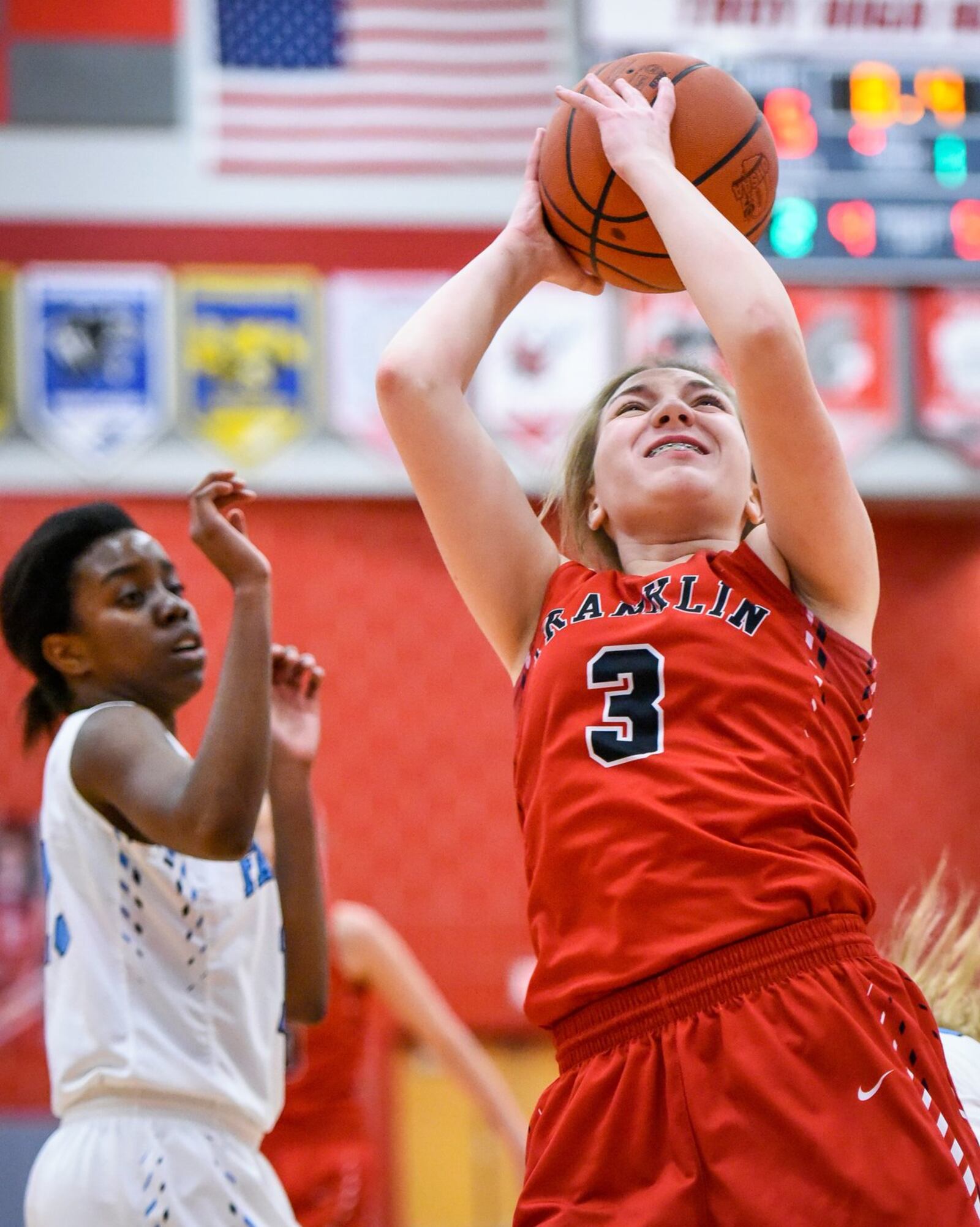 Franklin’s Kaylee Harris gets past Fairborn’s Marina Suarez and puts up a shot during Monday night’s Division I sectional contest at Troy. NICK GRAHAM/STAFF