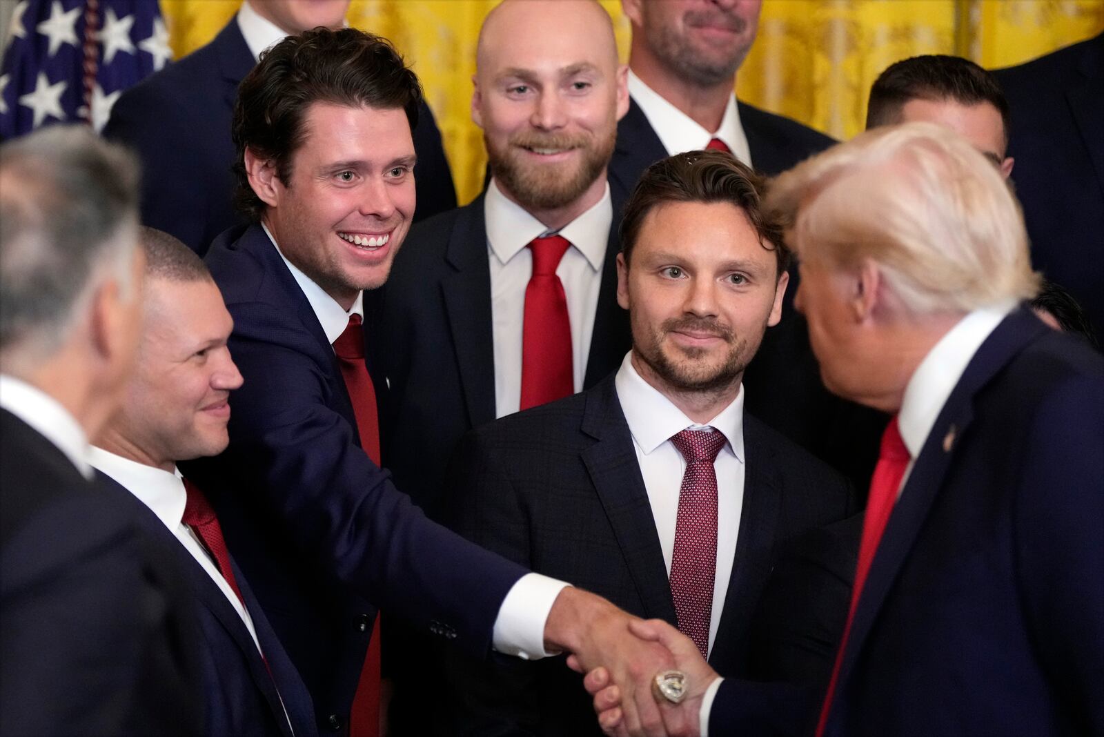 President Donald Trump shakes hands with Carter Verhaeghe as he speaks during a ceremony with the Florida Panthers NHL hockey team to celebrate their 2024 Stanley Cup victory in the East Room of the the White House, Monday, Feb. 3, 2025, in Washington. (AP Photo/Alex Brandon)