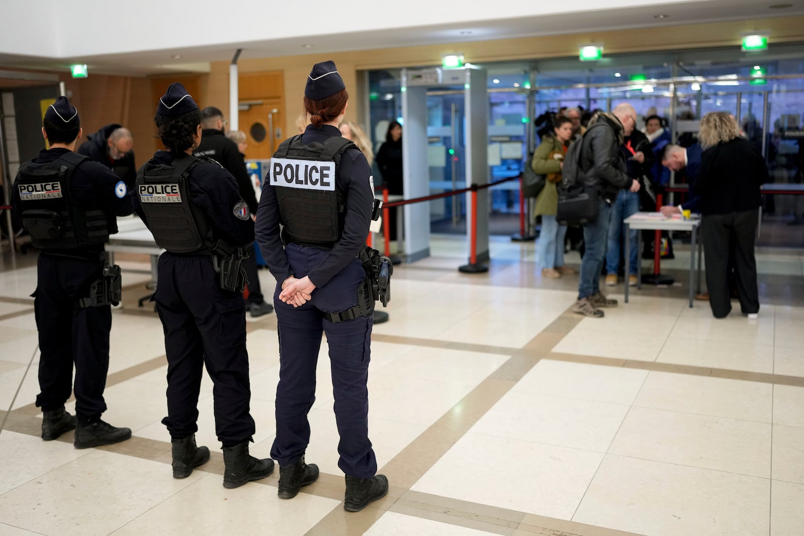 Police officers stand guard inside the courthouse of Avignon during the trial of four dozen men charged with aggravated rape and sexual assault on Gisèle Pelicot, in Avignon, southern France, Thursday, Dec. 19, 2024. (AP Photo/Lewis Joly)