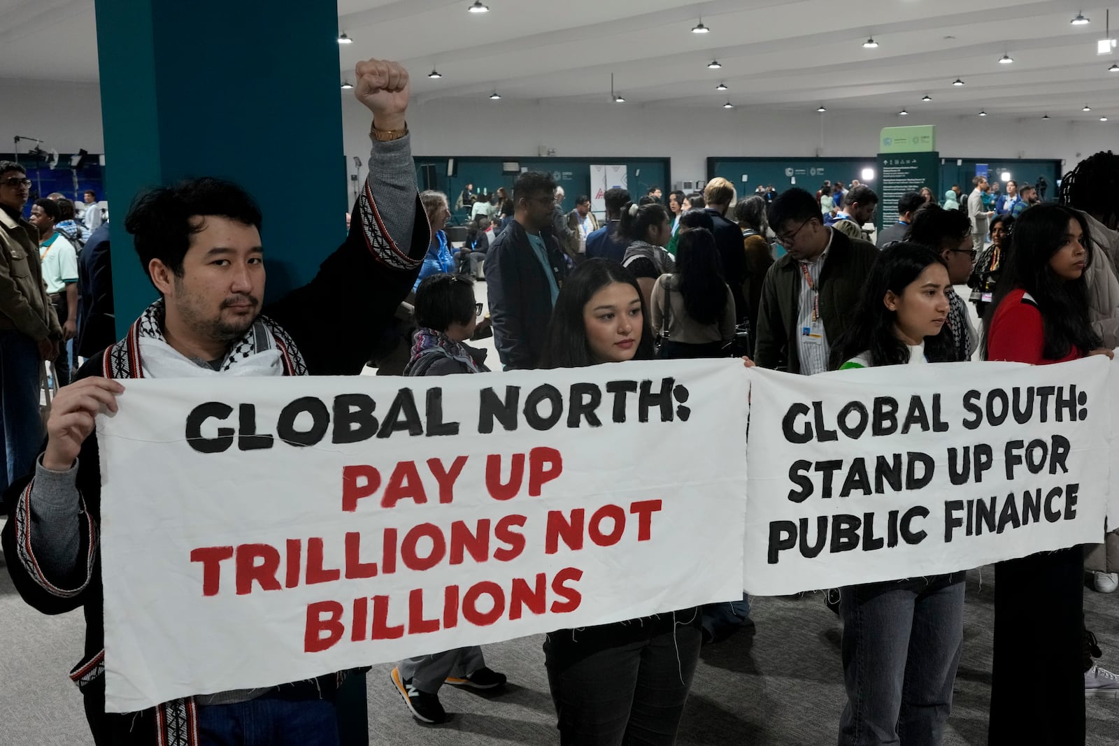 Activists demonstrate for climate finance at the COP29 U.N. Climate Summit, Wednesday, Nov. 20, 2024, in Baku, Azerbaijan. (AP Photo/Rafiq Maqbool)