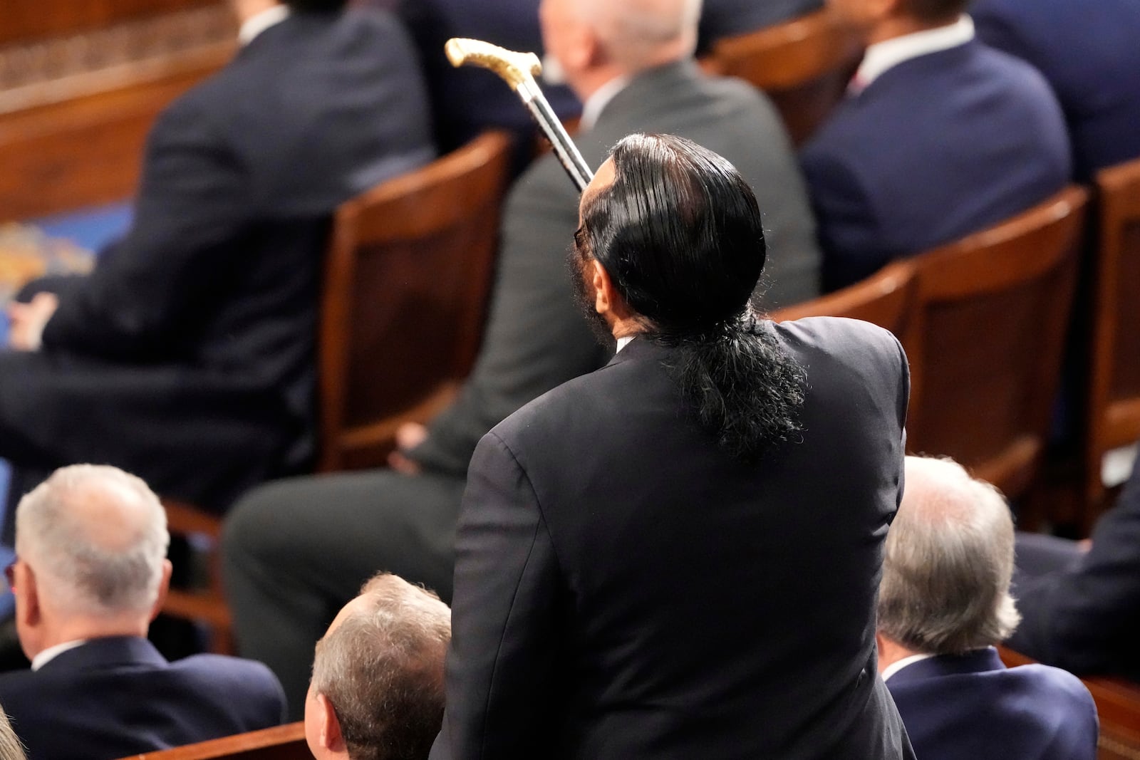 Rep. Al Green, D-Texas, gestures with a cane as President Donald Trump addresses a joint session of Congress at the Capitol in Washington, Tuesday, March 4, 2025. (AP Photo/Ben Curtis)