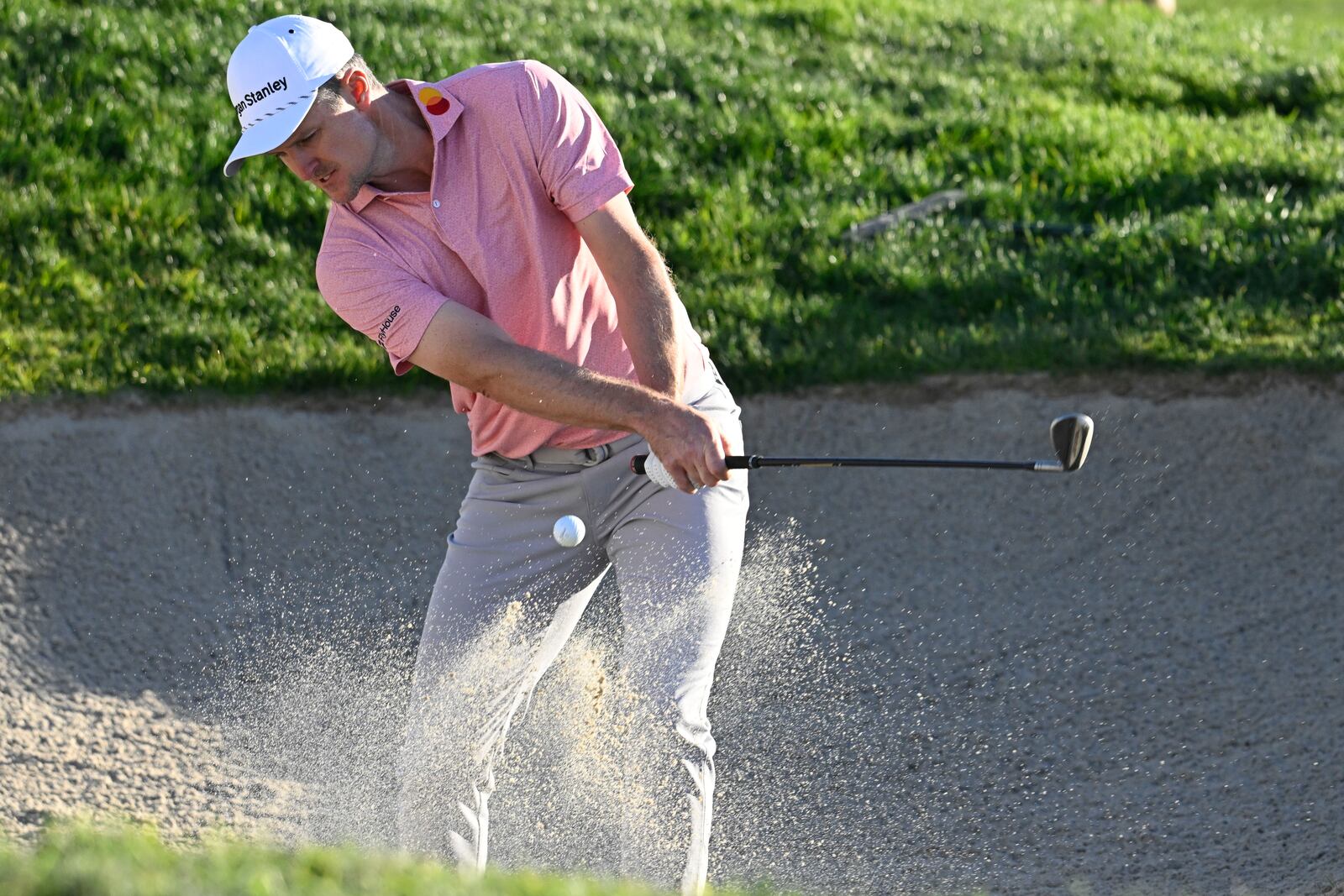 Maverick McNealy hits out of a bunker on the 13th hole of the South Course at Torrey Pines during the second round of the Farmers Insurance Open golf tournament Thursday, Jan. 23, 2025, in San Diego. (AP Photo/Denis Poroy)