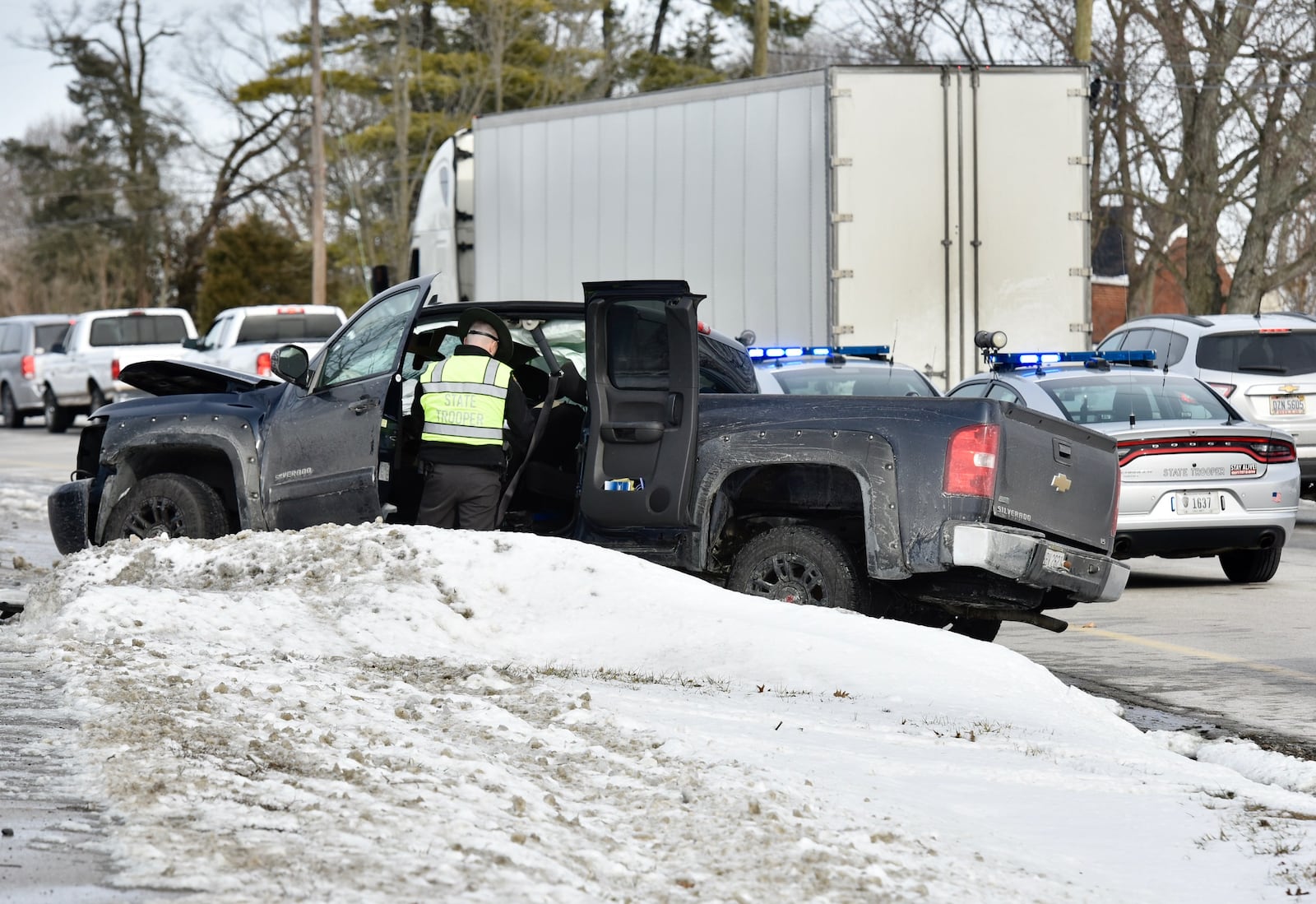 A Monroe police officer was injured while in route to a suspicious person call Tuesday afternoon after being involved in a crash with a truck in the 6100 block of Hamilton-Middletown Road. NICK GRAHAM/STAFF