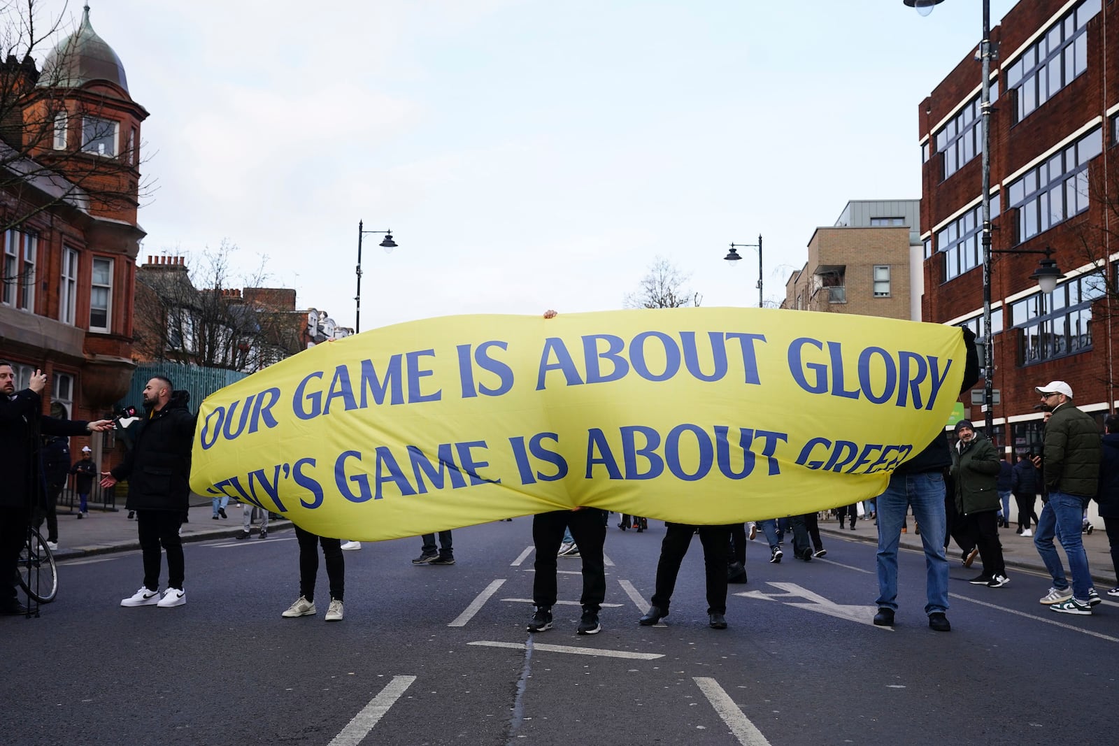 Tottenham Hotspur fans protest against the club owners ahead of the Premier League match between Tottenham and Manchester United at the Tottenham Hotspur Stadium, London, Sunday Feb. 16, 2025. (John Walton/PA via AP)