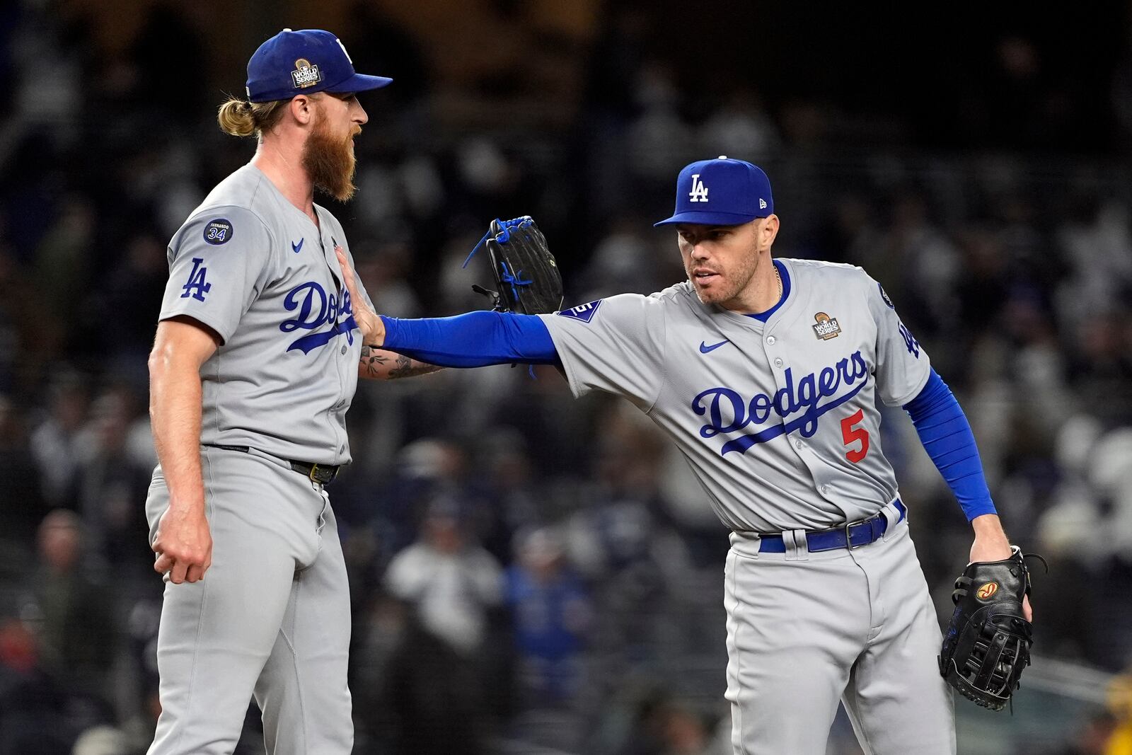 Los Angeles Dodgers' Freddie Freeman (5) and Michael Kopech celebrate after Game 3 of the baseball World Series against the New York Yankees, Monday, Oct. 28, 2024, in New York. The Dodgers won 4-2. (AP Photo/Godofredo A. Vásquez)