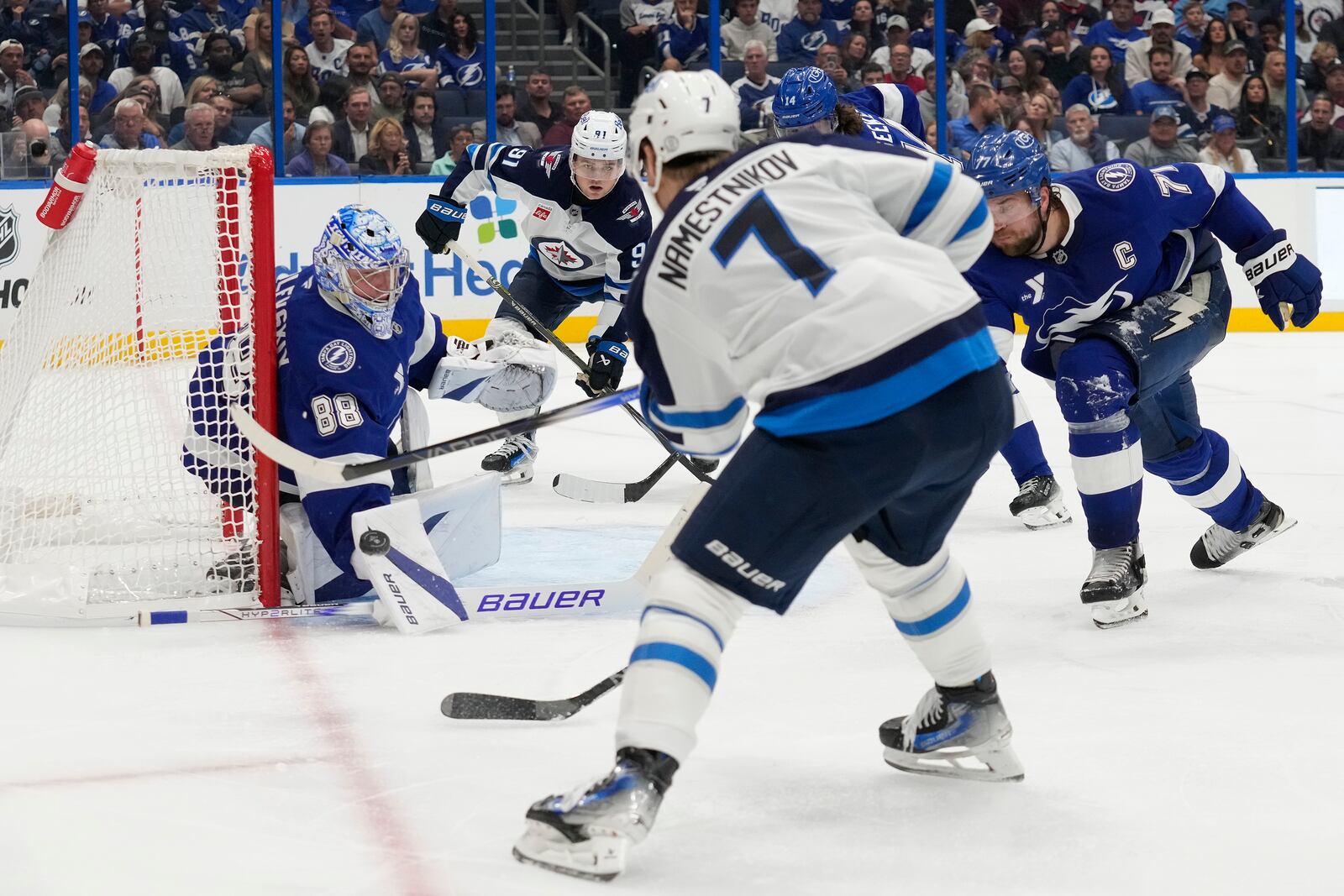 Tampa Bay Lightning goaltender Andrei Vasilevskiy (88) stops a shot by Winnipeg Jets center Vladislav Namestnikov (7) during the third period of an NHL hockey game Thursday, Nov. 14, 2024, in Tampa, Fla. (AP Photo/Chris O'Meara)