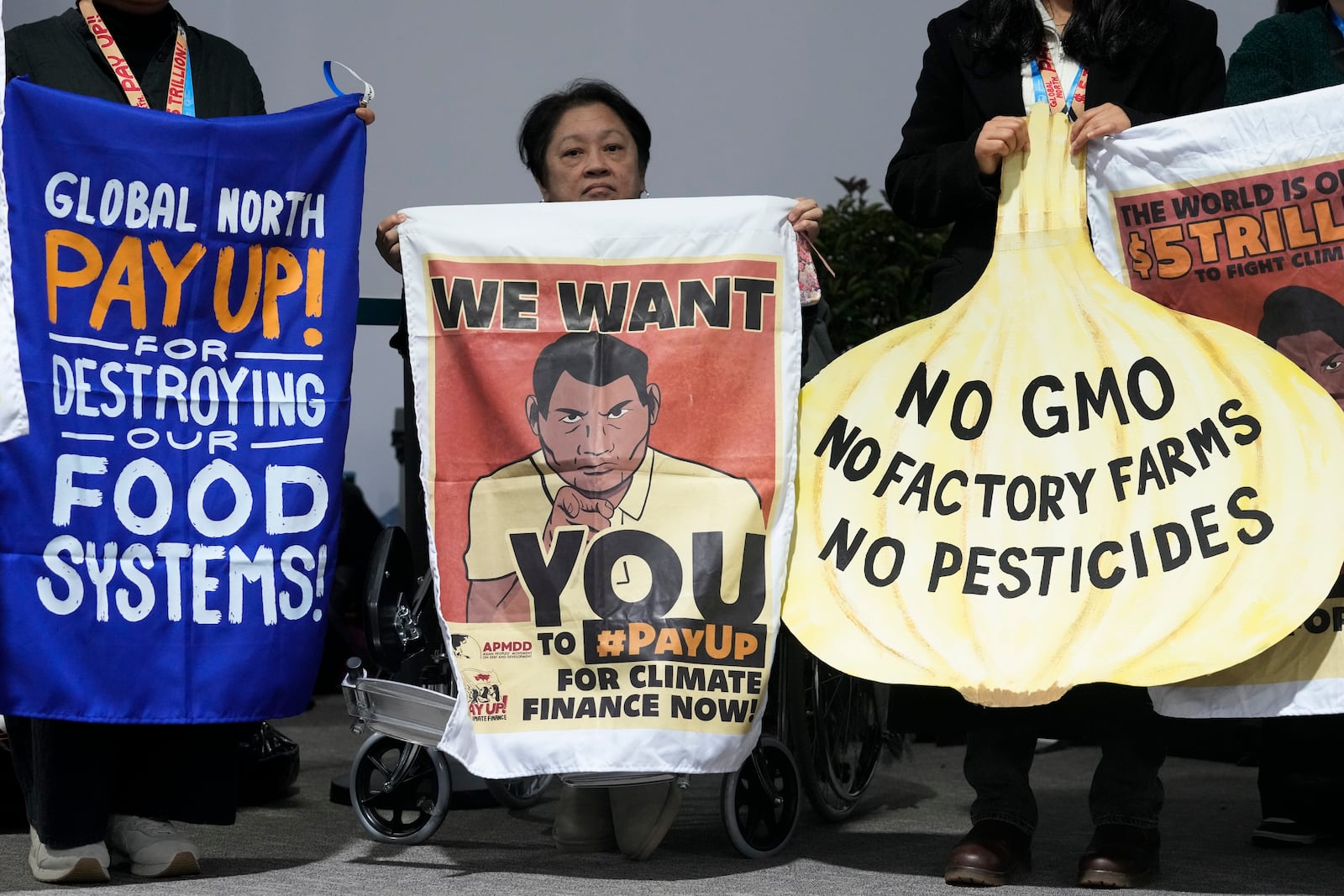 Activists participate in a demonstration for transforming food systems at the COP29 U.N. Climate Summit, Tuesday, Nov. 19, 2024, in Baku, Azerbaijan. (AP Photo/Rafiq Maqbool)