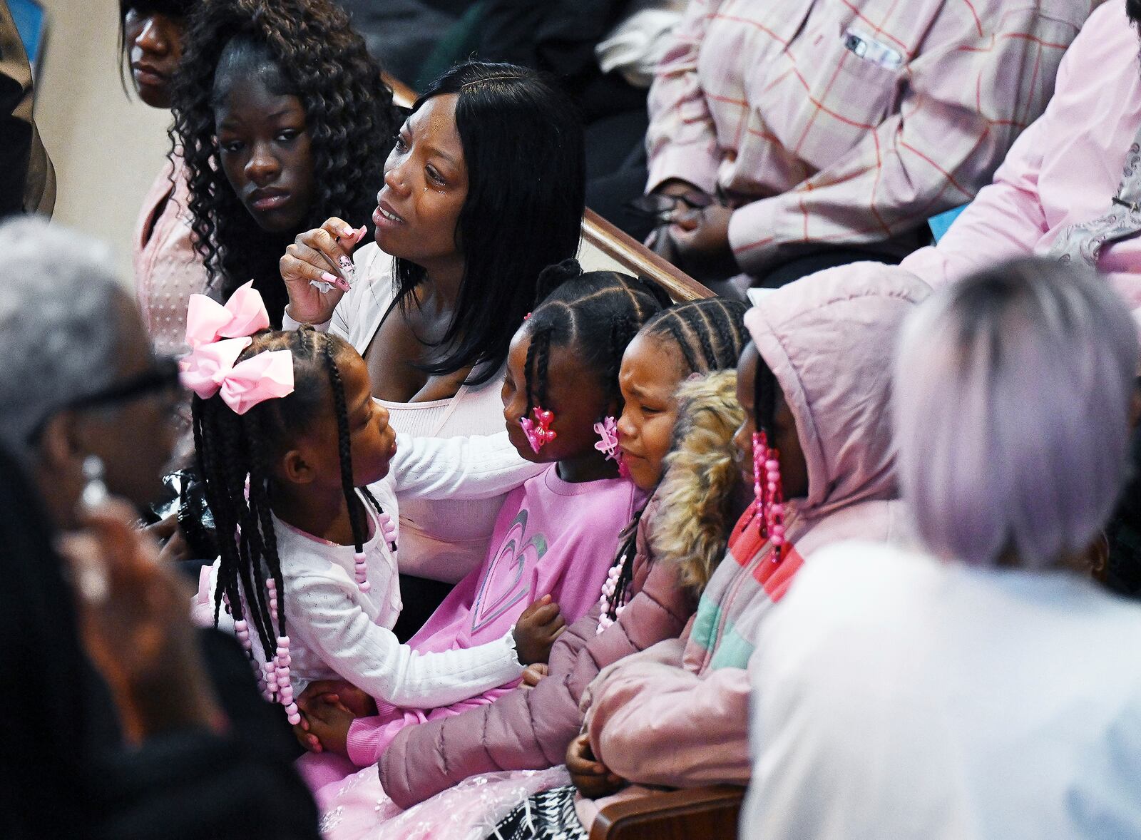 Tateona Williams, the mother of A'millah Currie, 2, and Darnell Currie, Jr., gets emotional with other siblings before the start of the funeral services at Triumph Church on Thursday, Feb. 20, 2025, in Detroit. (Clarence Tabb Jr./Detroit News via AP)