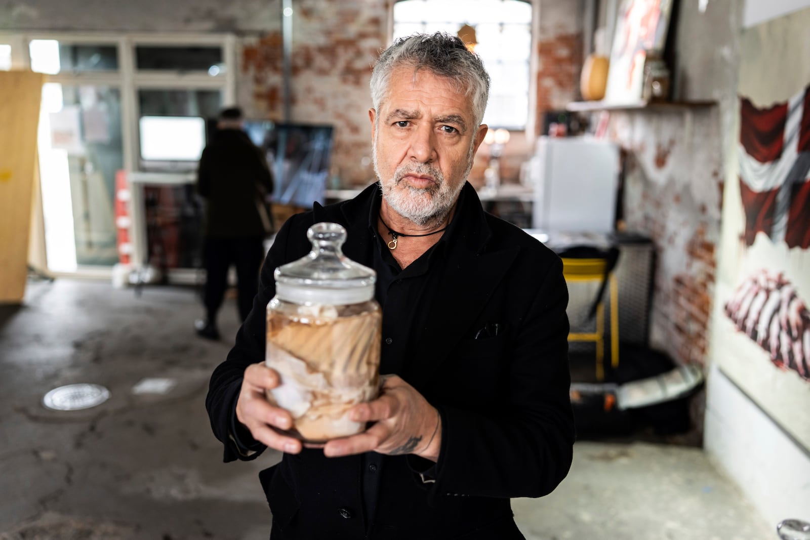 Artist Marco Evaristtis is photographed with his exhibition "And now you care", before the opening in Den Graa Koedby in Copenhagen, Friday, Feb. 28, 2025. (Emil Nicolai Helms/Ritzau Scanpix via AP)